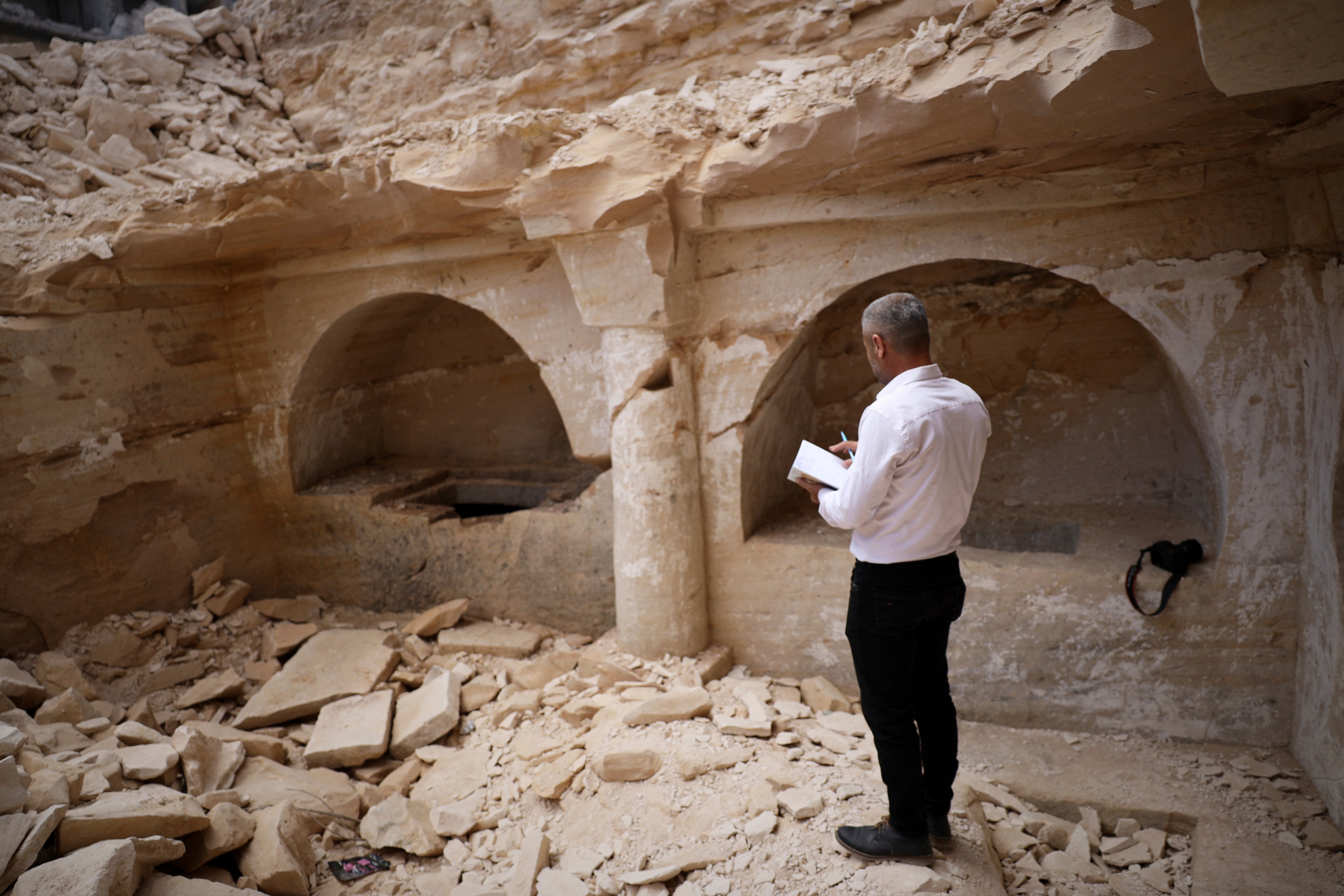Hassan Ismail of the Idlib Museum takes notes at the tomb complex