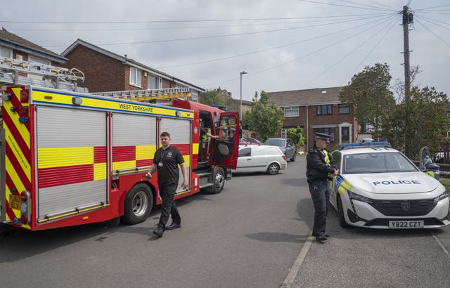 <p>Emergency services at the scene in Russell Close, Heckmondwike, West Yorkshire </p>