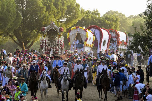 <p>Hundreds of thousands of devotees in traditional outfits converge in a burst of color in the El Rocio pilgrimage</p>