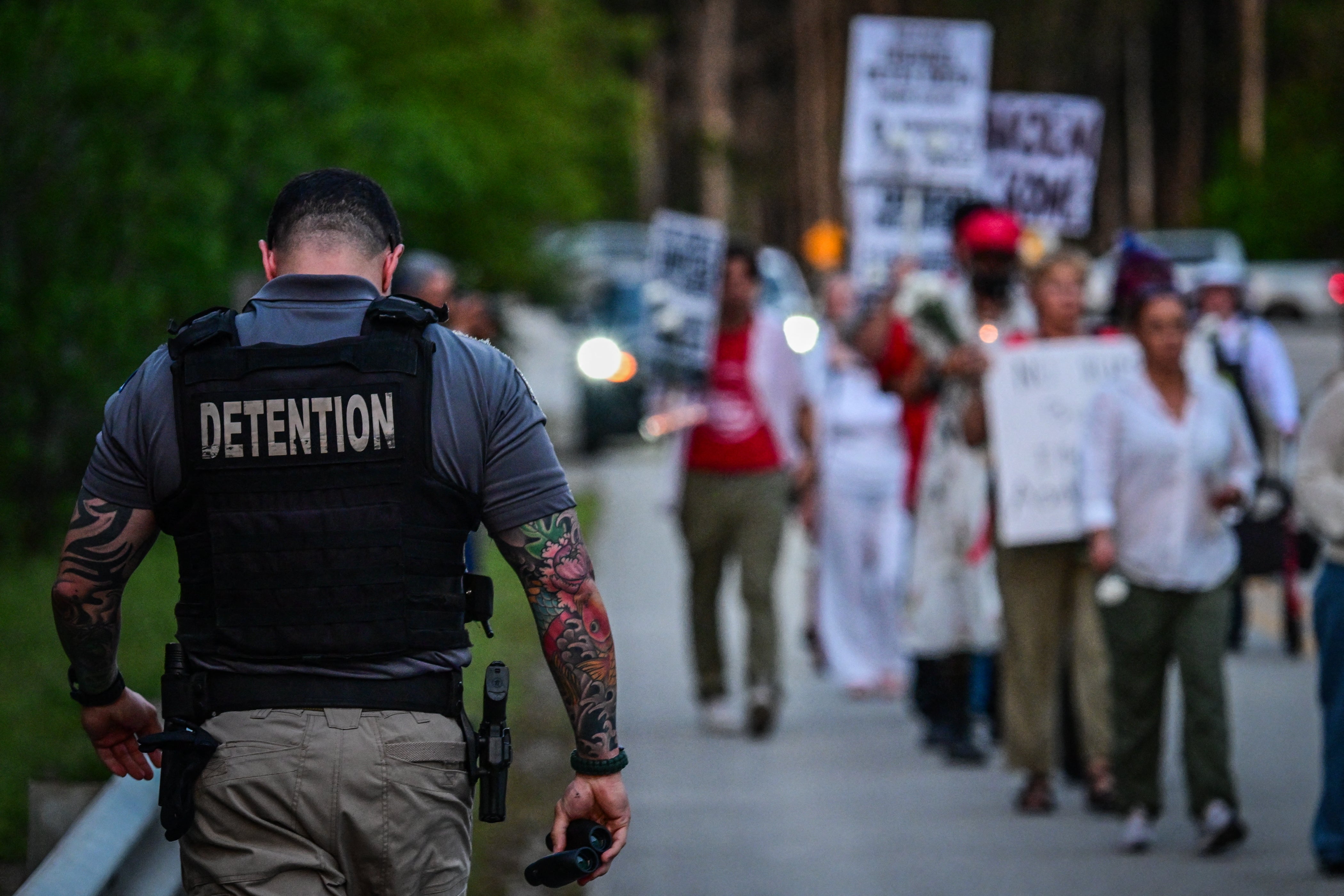 A corrections officer walks alongside protesters in Miami demonstrating against the Trump administration’s immigration enforcement agenda. At least two prominent Latino Republicans in Florida have criticized the president in recent days over courthouse arrests that sparked protests across the state