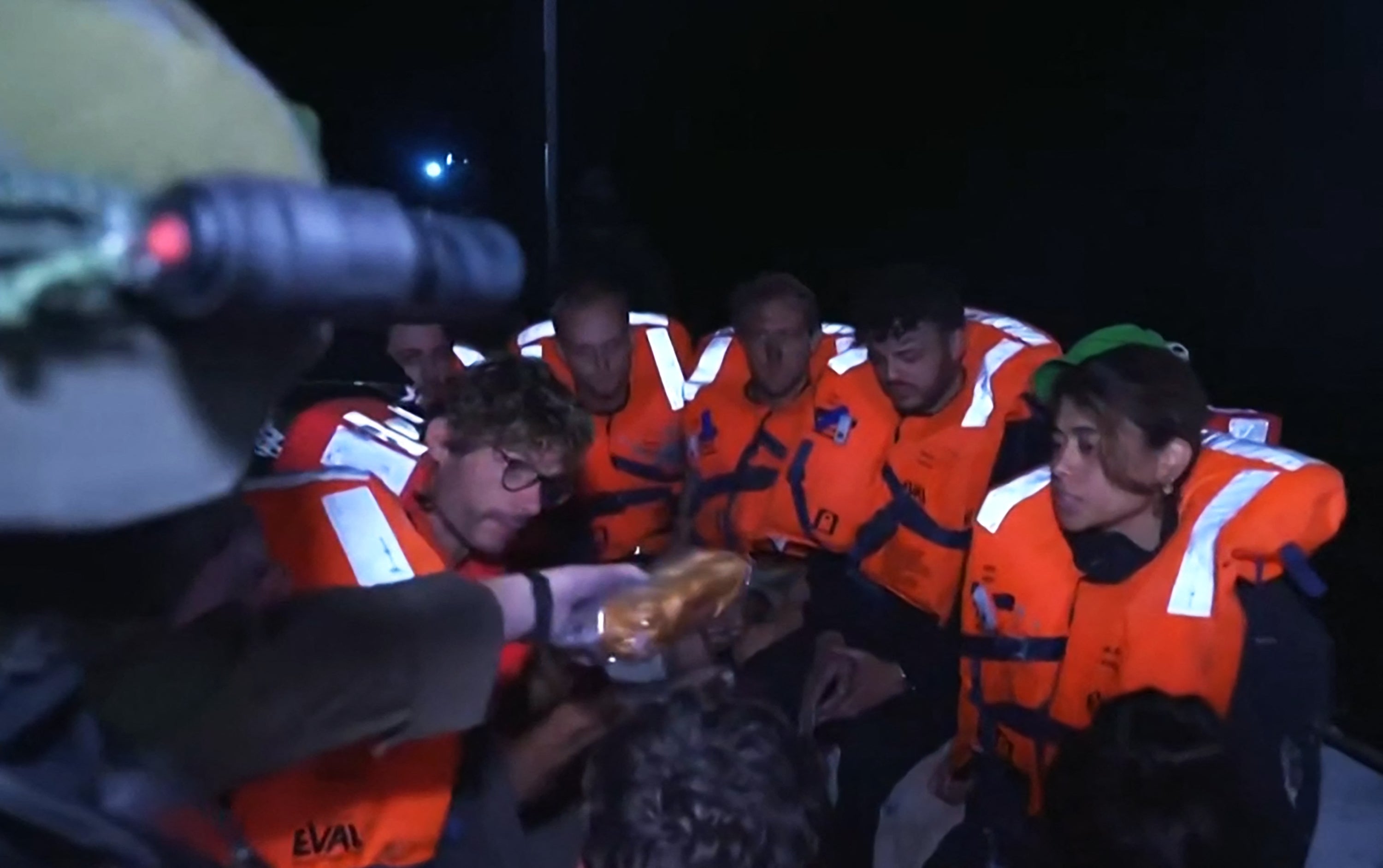 An image grab from footage published on the Israeli Foreign Ministry's X accountshow what the ministry said were passengers of the Madleen Gaza-bound aid boat being given sandwiches after the vessel was intercepted