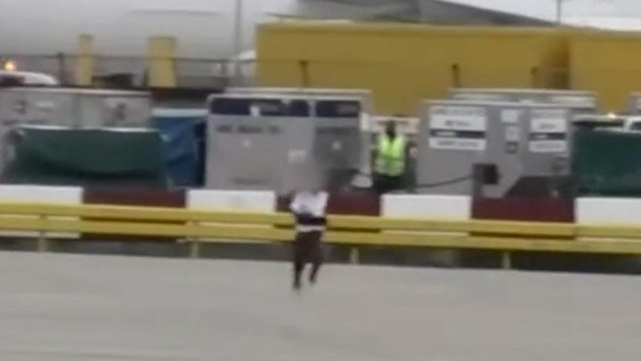 <p>Moment man chased across Heathrow Airport tarmac as he runs around moving planes.</p>