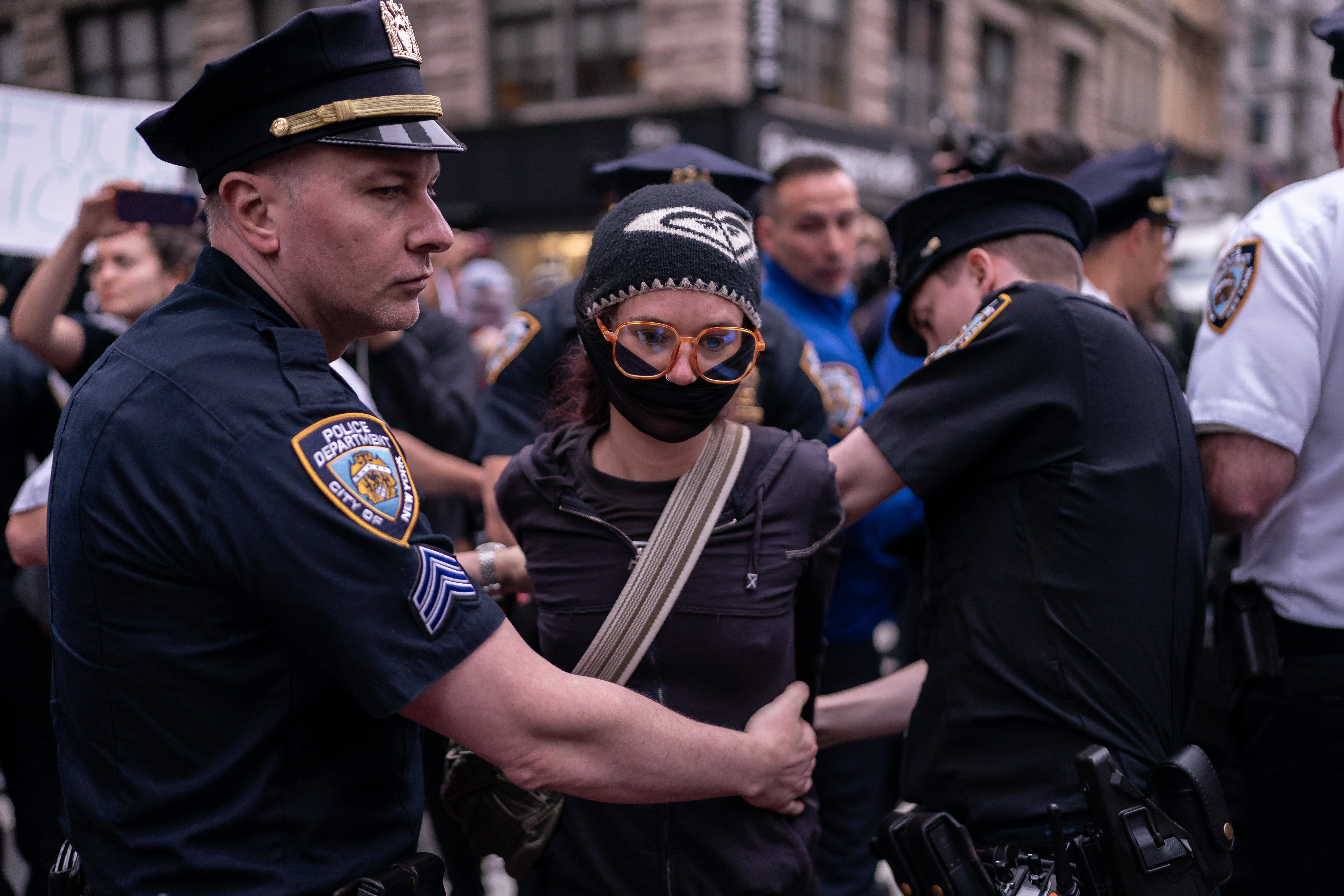 A person is detained by NYPD Strategic Response Group officers for blocking a law enforcement vehicle outside of the Jacob K Javits Federal Building in New York