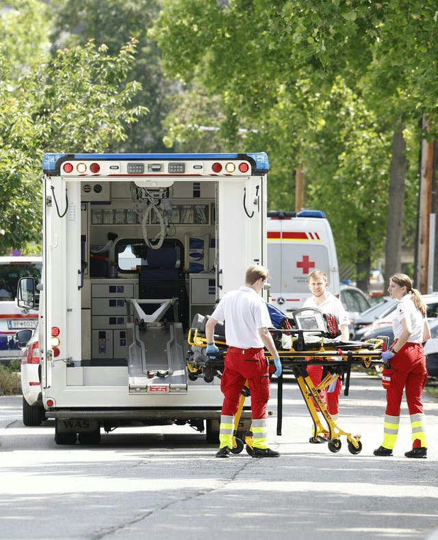 <p>Rescue paramedics are seen in a street close to a school where, according to reports, several people died in a shooting, on 10 June in Graz</p>