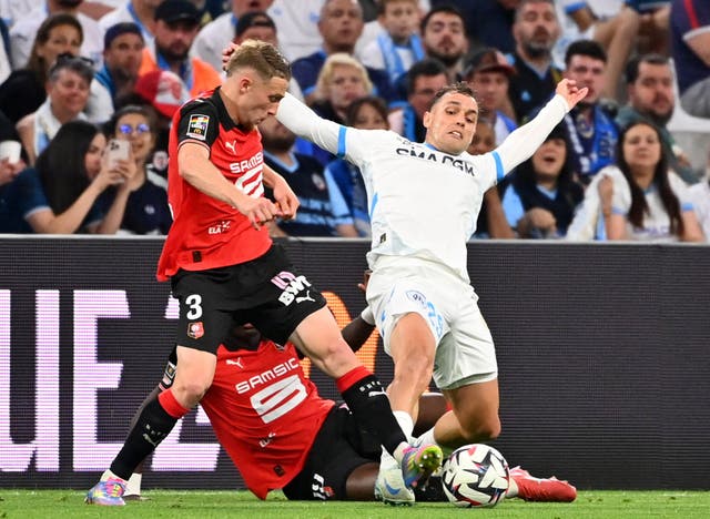 <p>Adrien Truffert, left, in action for Rennes</p>