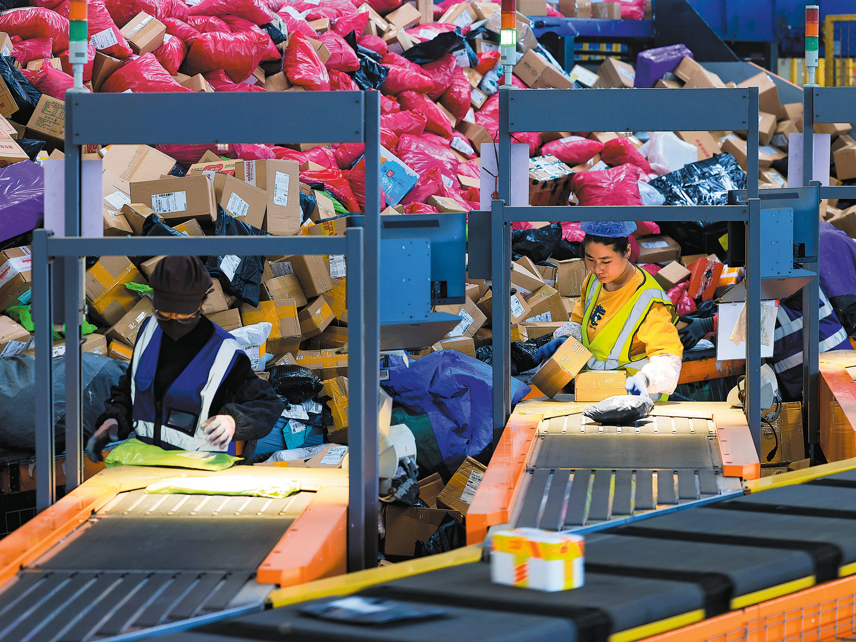 Piles of packages are processed at a distribution centre in Zaozhuang, Shandong province