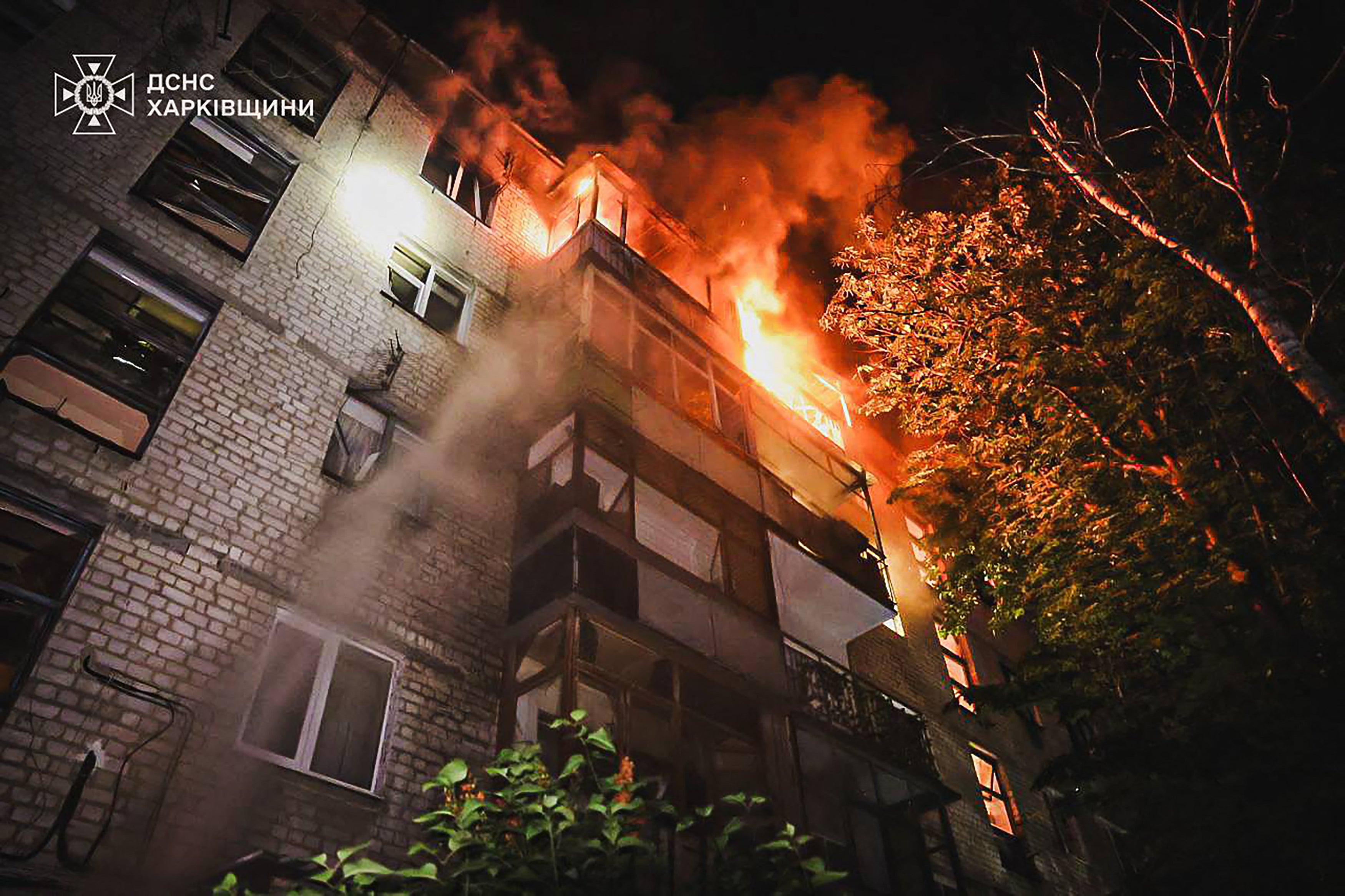 This handout photograph taken and released by the Ukrainian Emergency Service on June 11, 2025 shows a burning building following a drone attack in Kharkiv, amid the Russian invasion of Ukraine