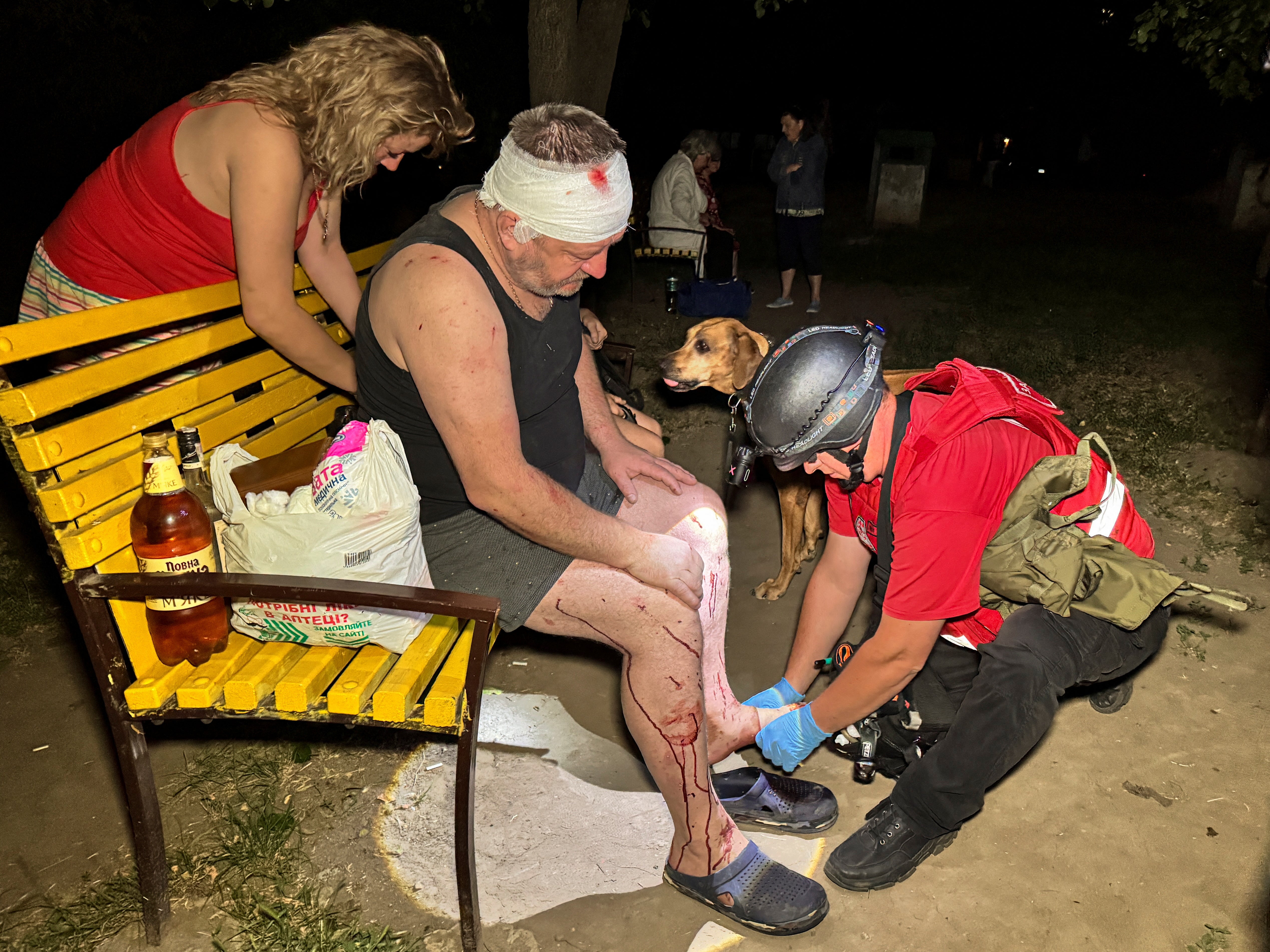 Emergency services attend to a man injured in Russian strikes on Kharkiv