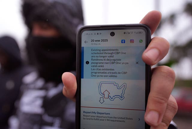 <p>A migrant seeking asylum holds up the CBP One app showing his appointment was canceled after Trump was sworn into office</p>