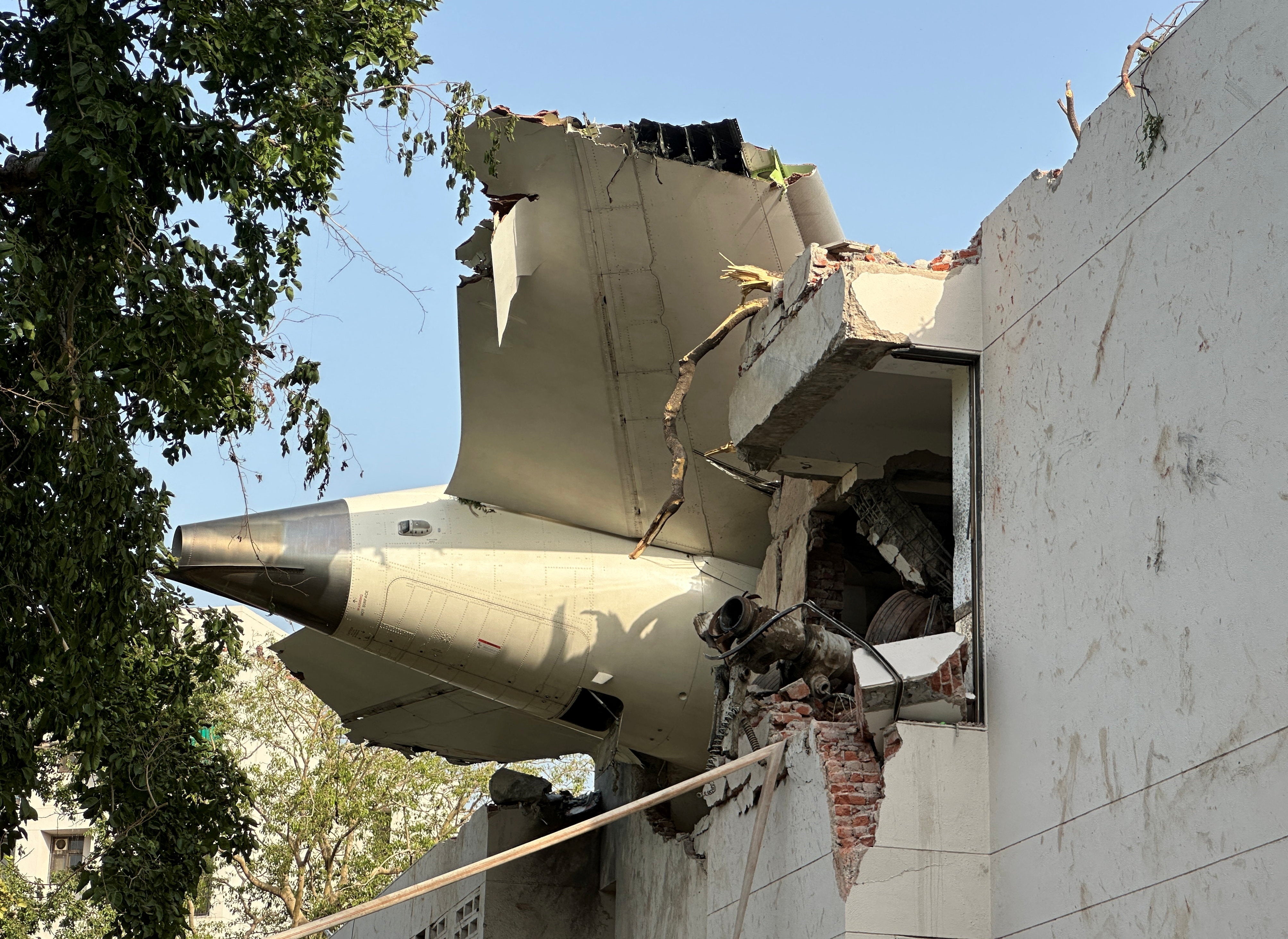 The tail of the Air India Boeing 787 Dreamliner plane could be seen stuck on a building