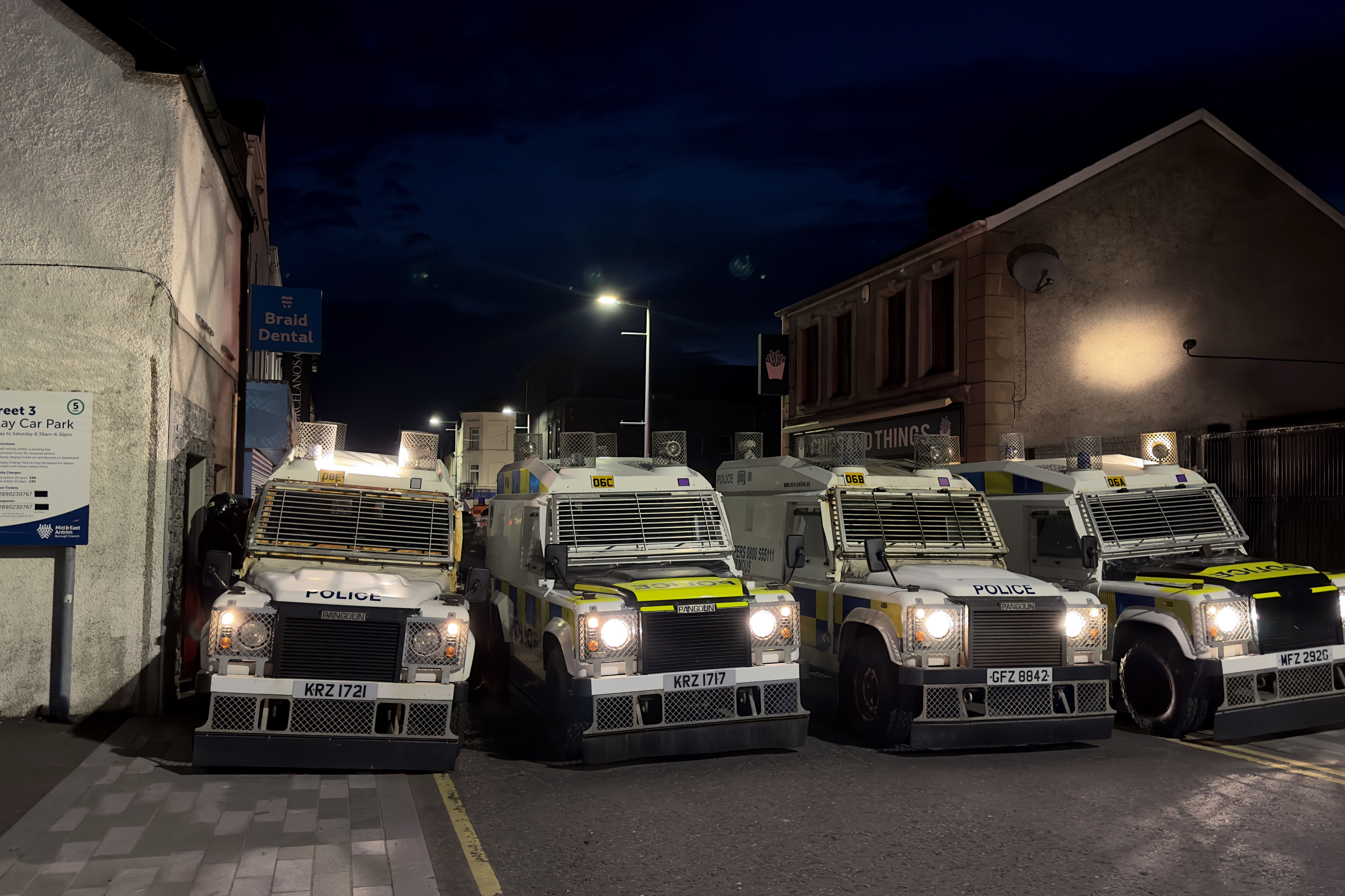 PSNI vehicles form a barricade during a third night of disorder in Ballymena (Liam McBurney/PA)