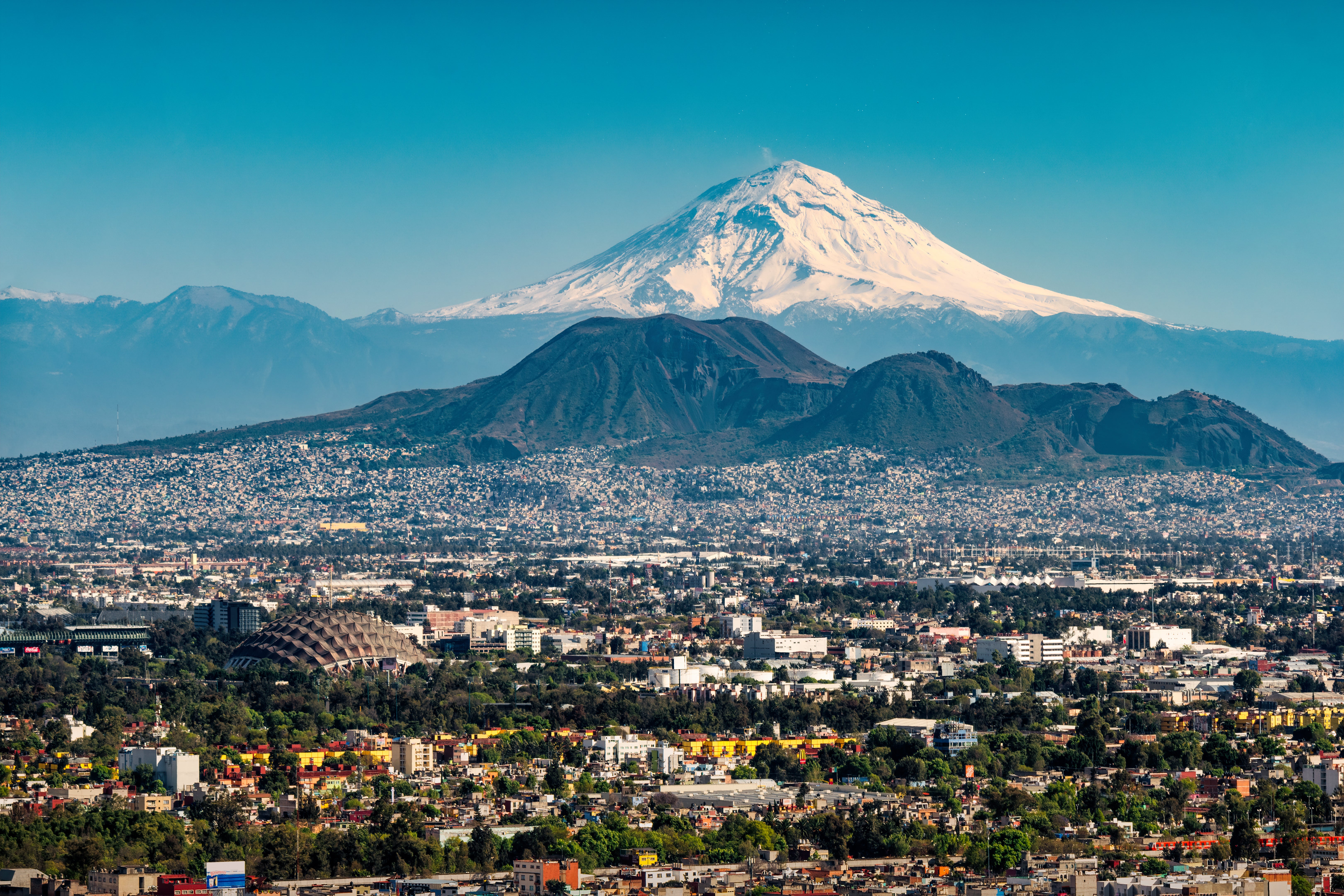 'I'm always down to return to Mexico City — I love the vibe,' says Sam. Pictured is a view across the city to volcano Popocatépetl