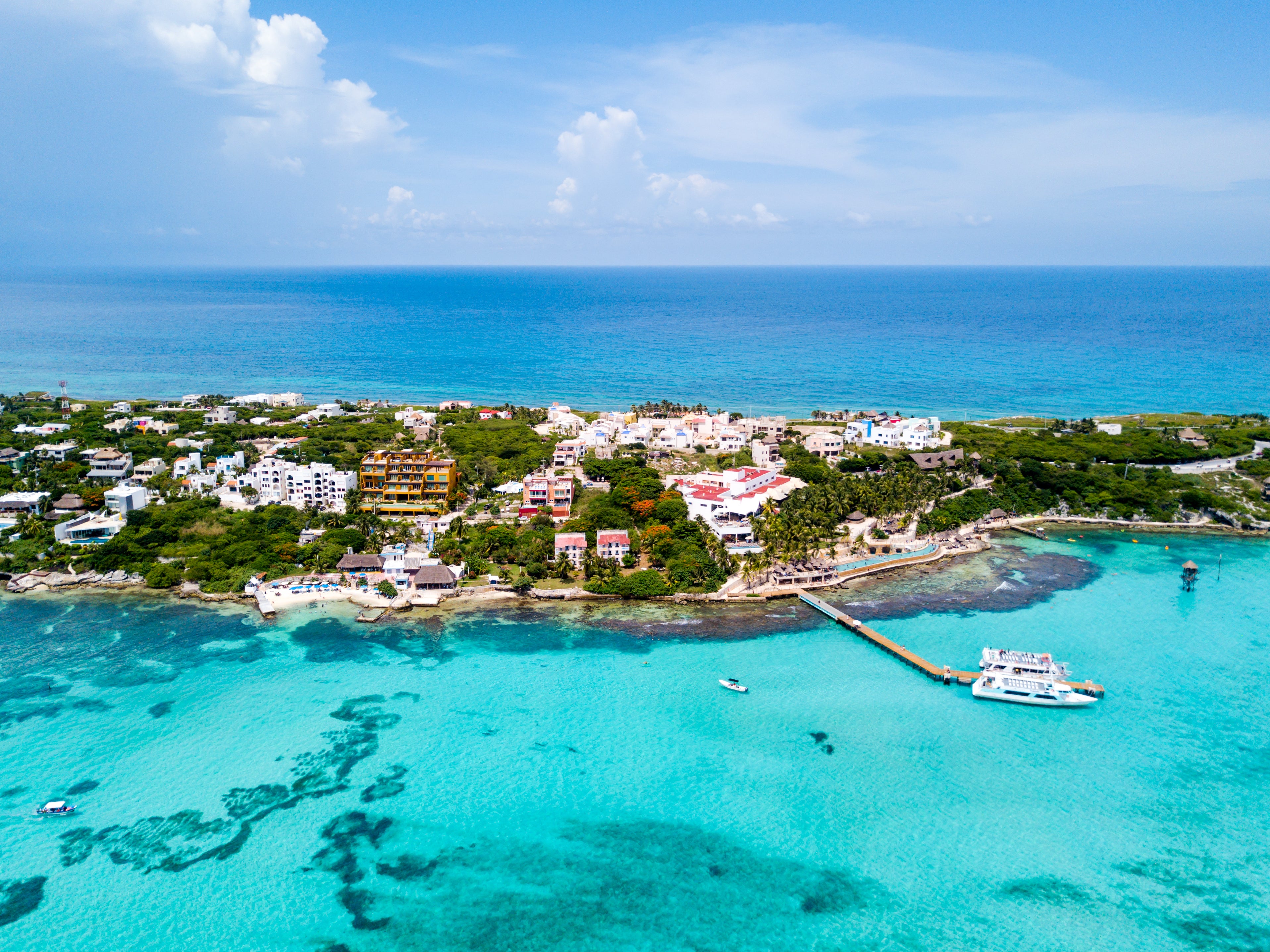Sam recalls being 'two pina coladas deep on Isla Mujeres on a rope swing over the water and feeling so happy and free'. Pictured is the island's Garrafon Natural Reef Park