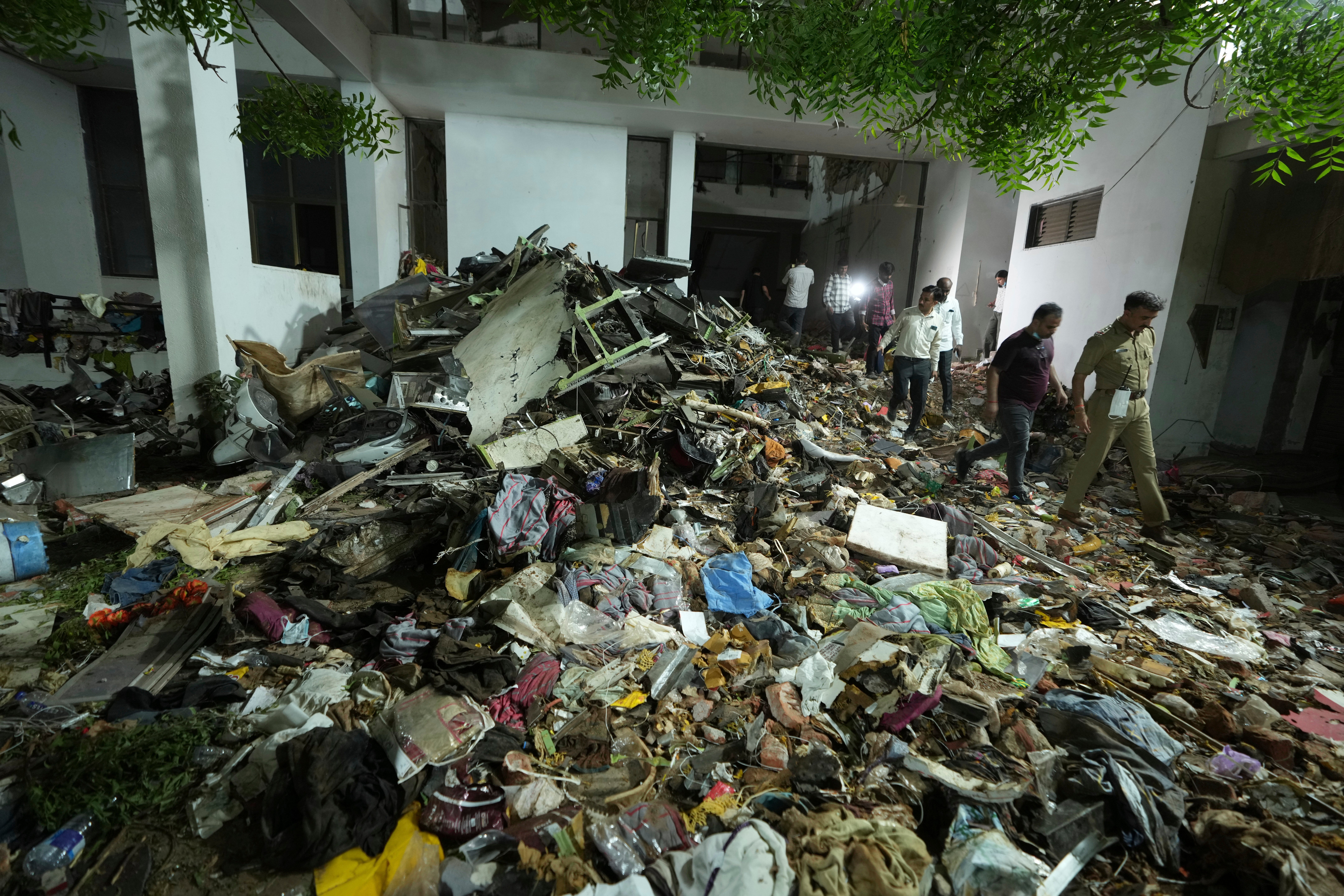 Search and recovery teams work through the rubble