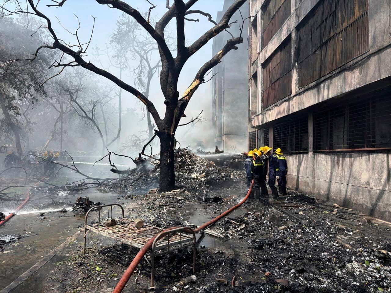 Firefighters work at the site of an airplane that crashed in India's northwestern city of Ahmedabad in Gujarat state