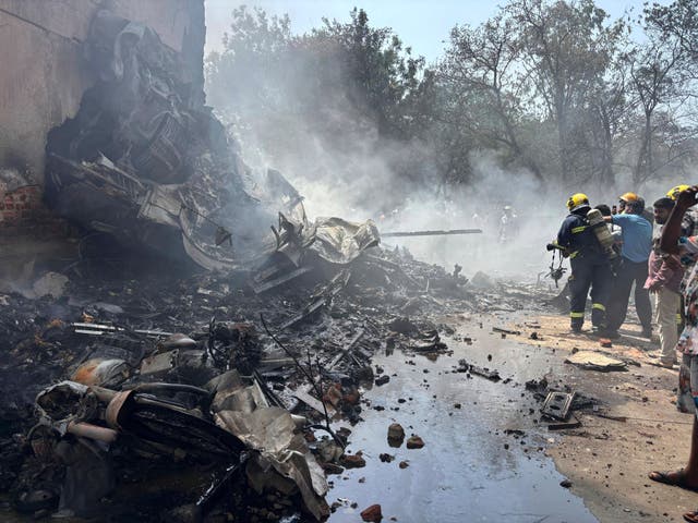 <p>Firefighters at the site of an airplane that crashed in India's northwestern city of Ahmedabad</p>