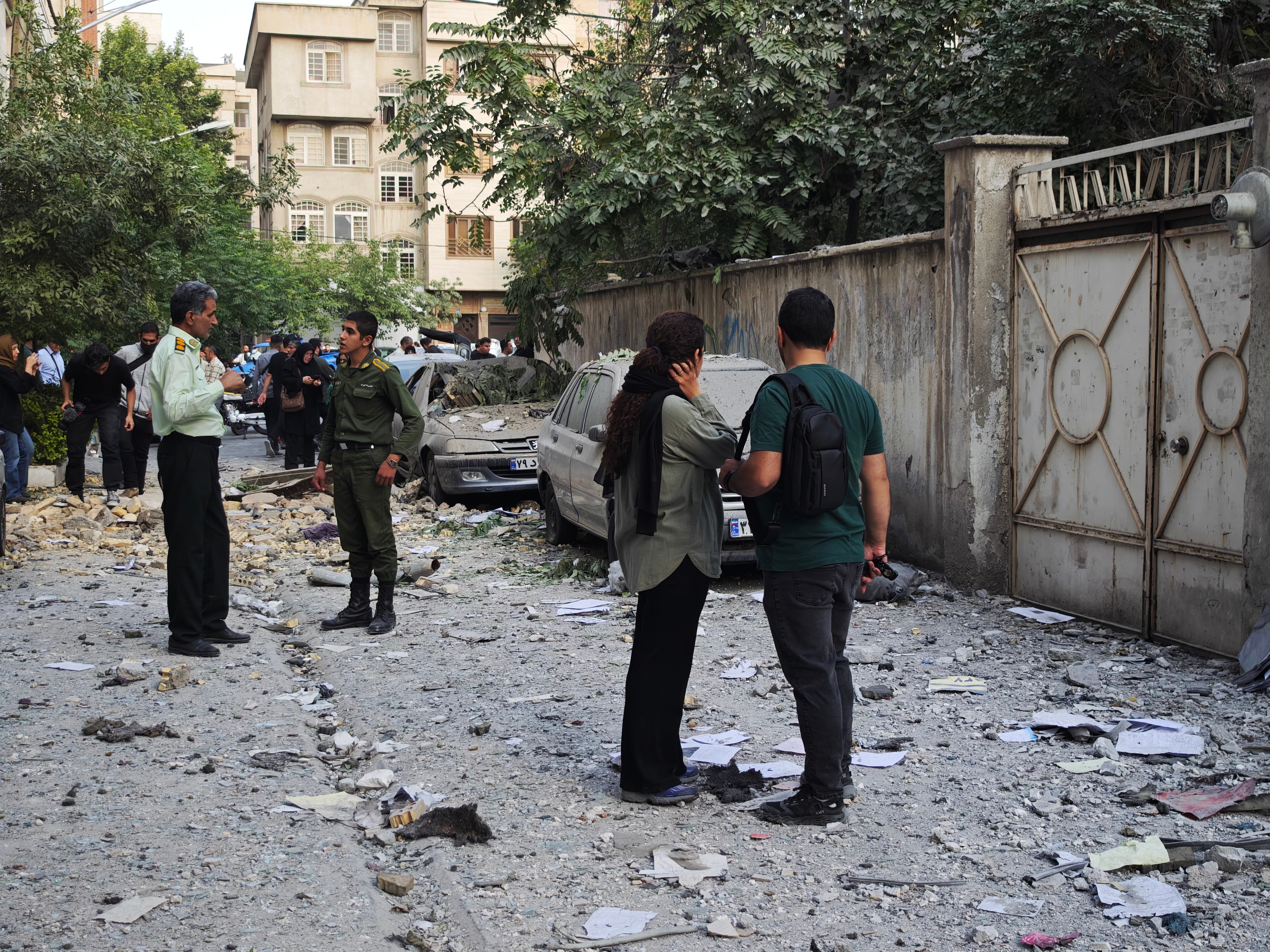 People look over damage following Israeli airstrikes on June 13, 2025 in Tehran, Iran. Iran's three top military generals were killed in the attacks that also targeted nuclear and military facilities, according to published reports. Israel described the strikes as preemptive to keep Iran from obtaining nuclear weapons, the reports said