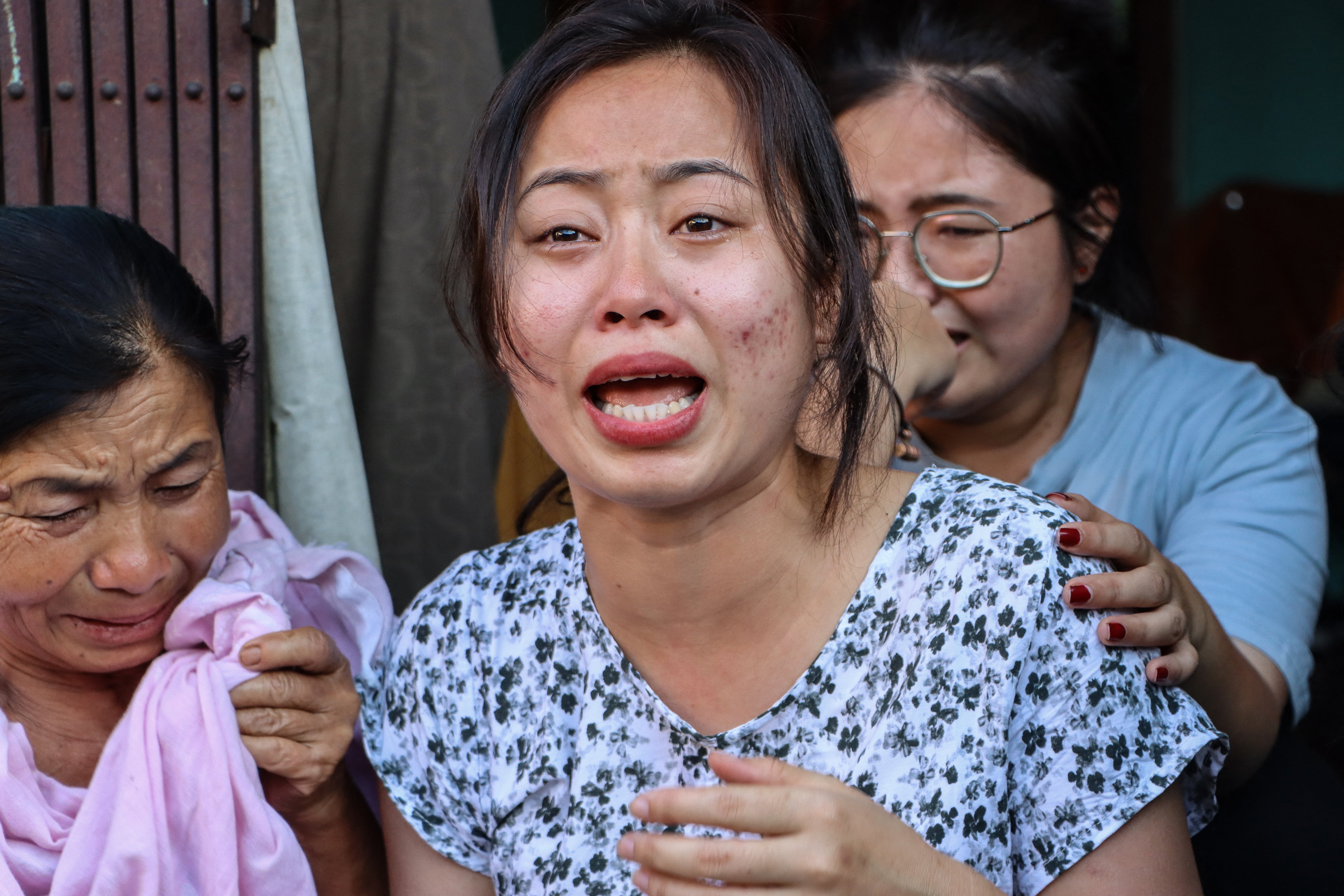 Family members of one of the crew members of Air India flight 171 mourn at their residence in Thoubal Mayai Leikai near Imphal in the Indian state of Manipur