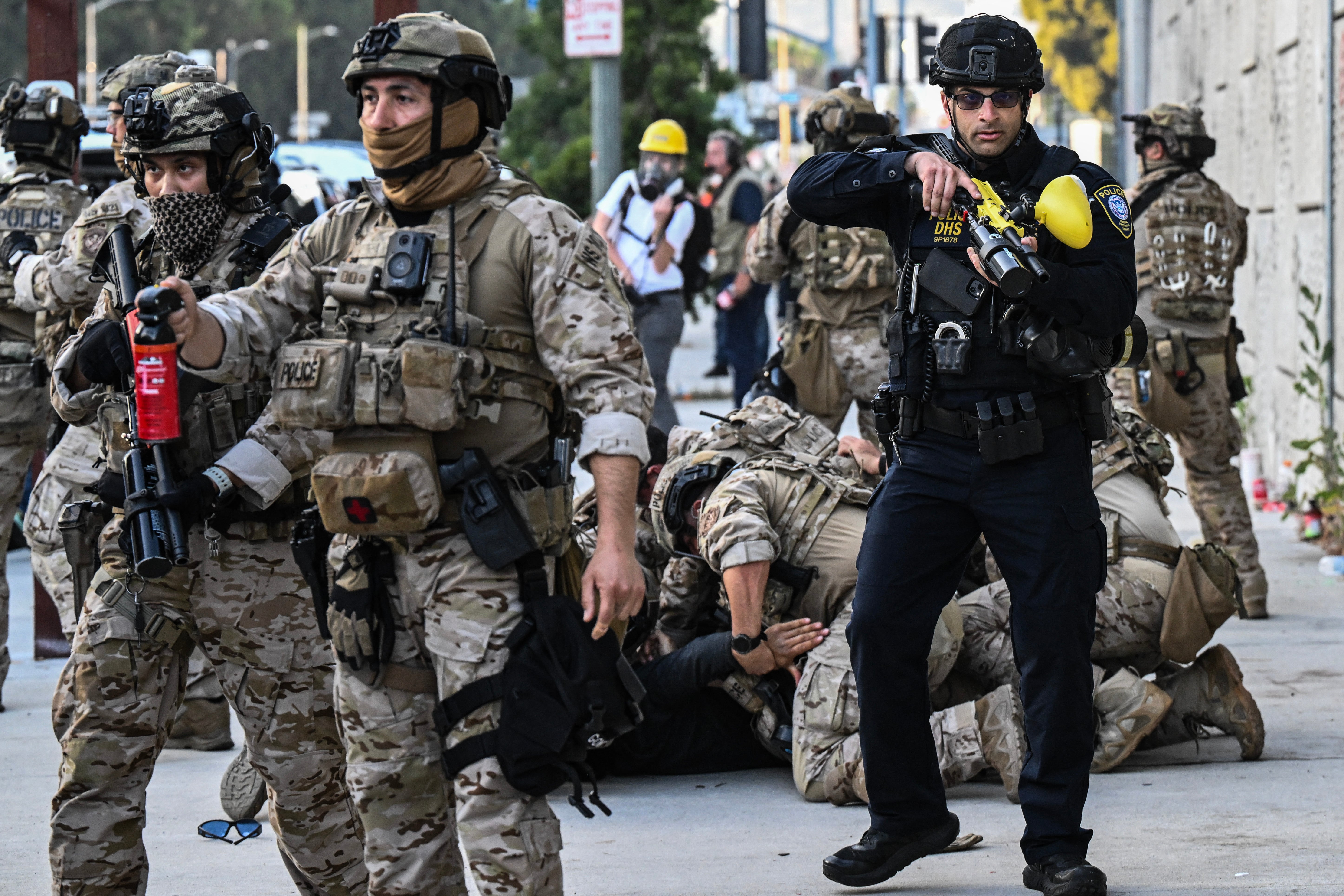 US Customs and Border Protection agents arrest a protester in front of the Federal Building