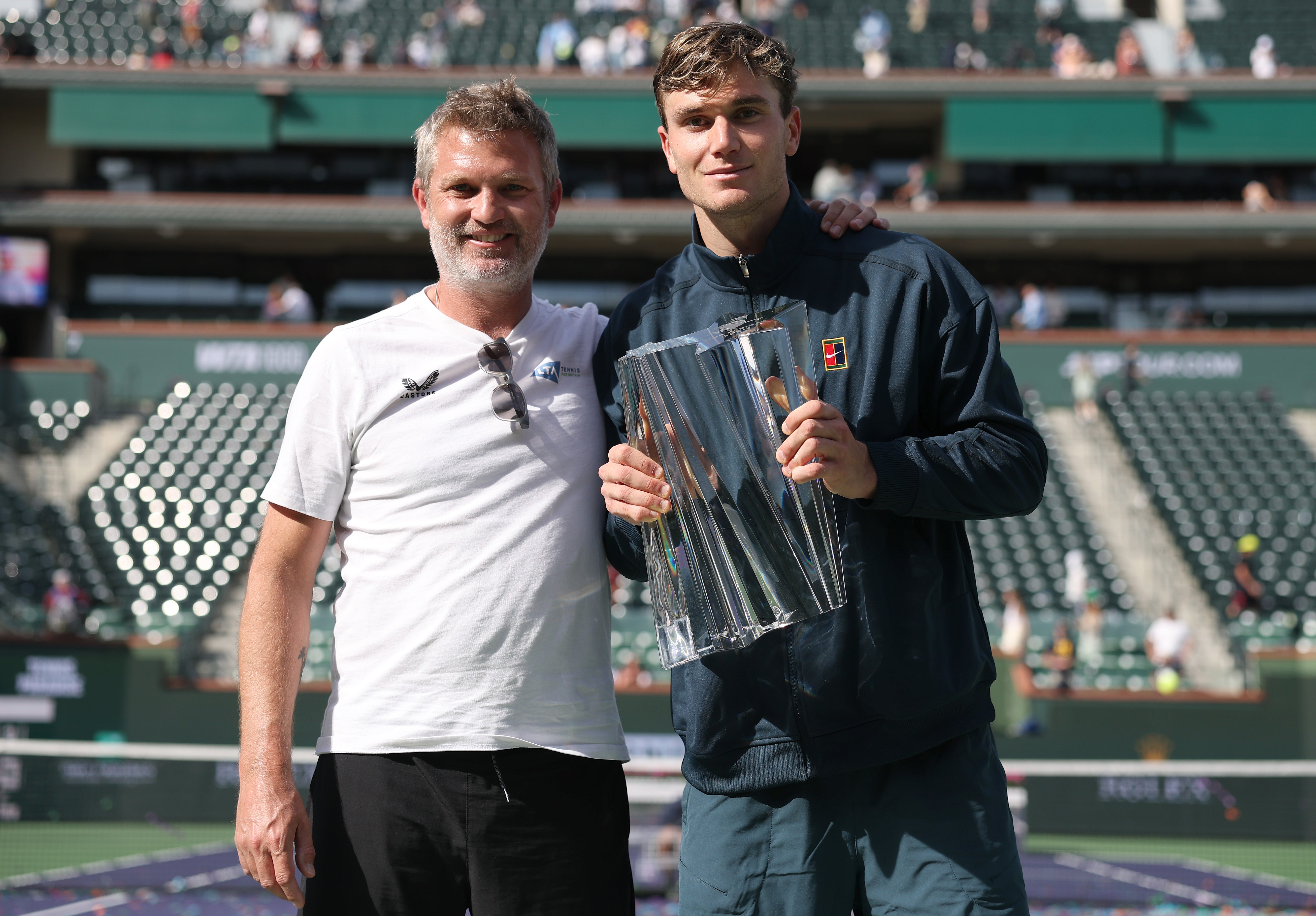Draper celebrates his Indian Wells title with coach James Trotman