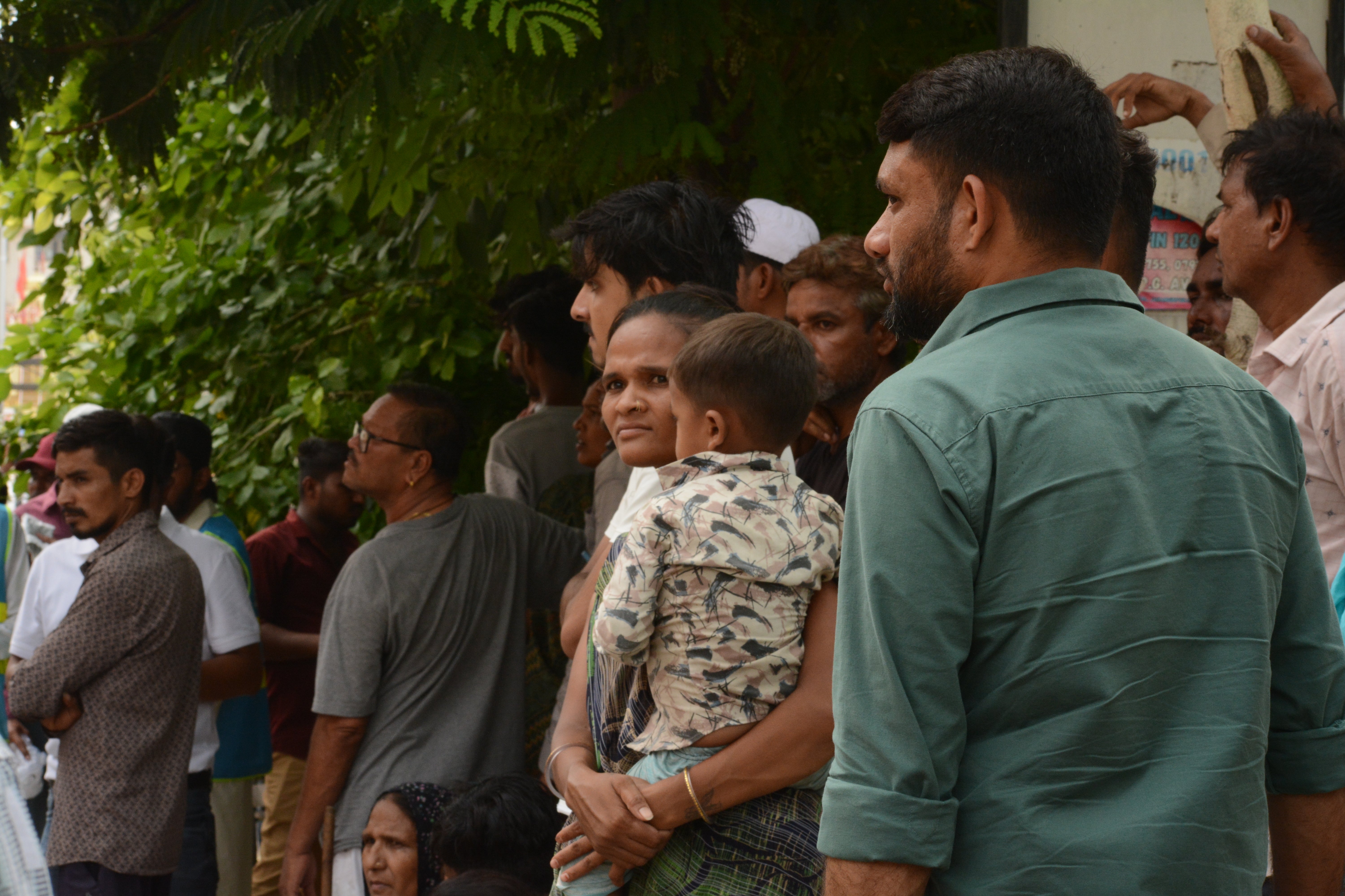Scores of people waiting outside the Civil Hospital's post mortem room as they await information on their loved ones