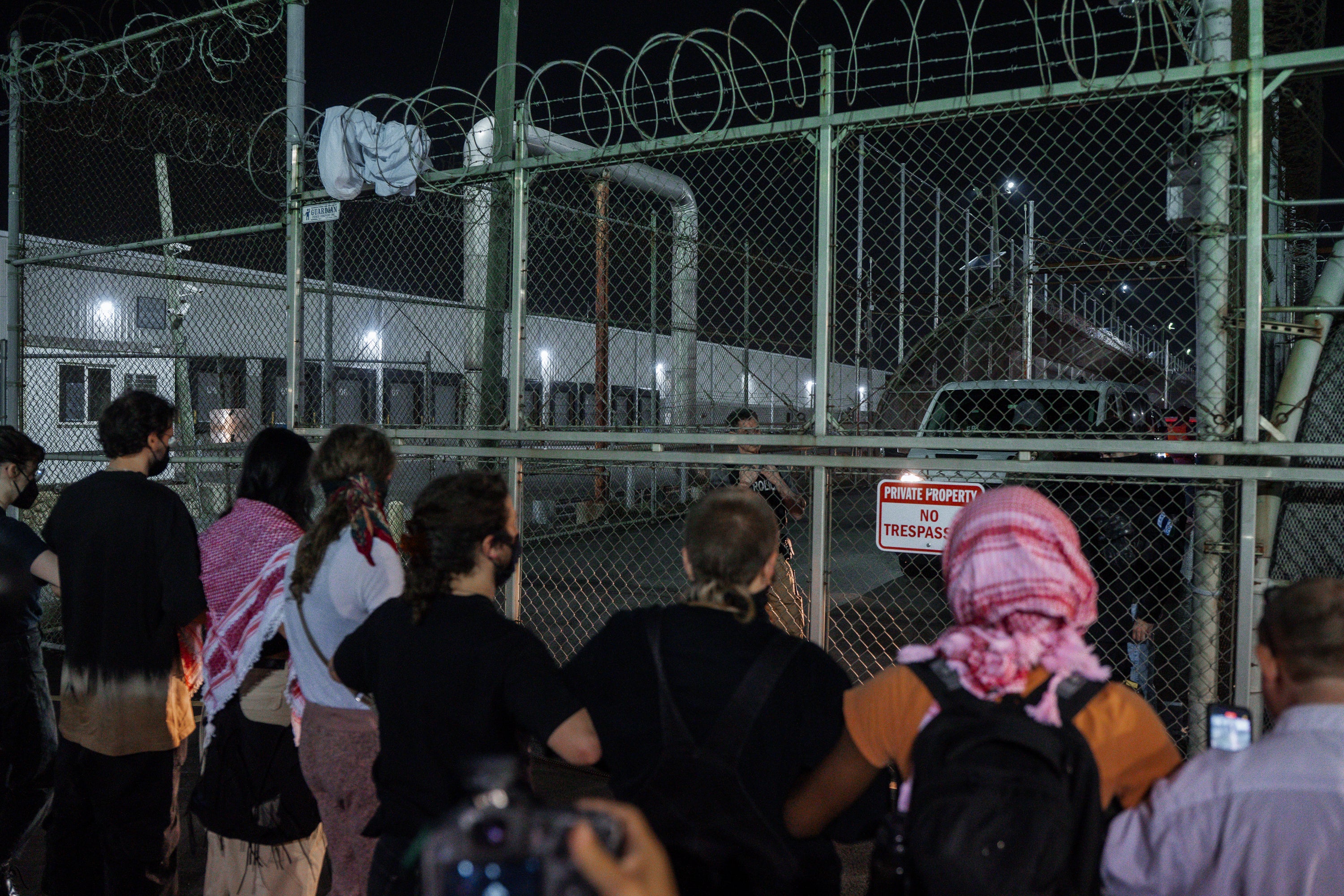 Protesters linked arms to block the entrance to the immigration detention facility Delaney Hall