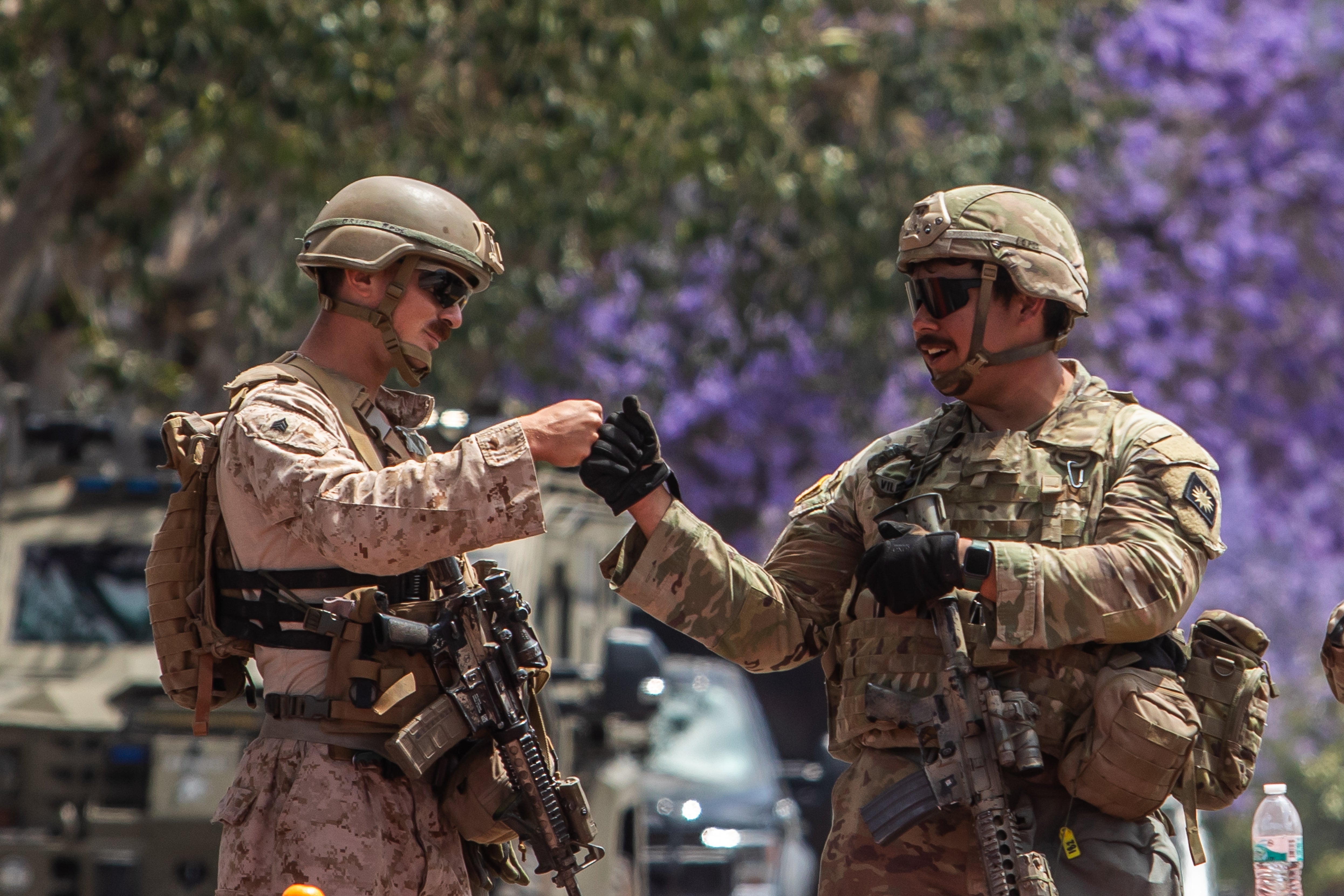 A U.S. Marine (L) greets a California National Guard (R) in the parking lot of the Wilshire Federal Building on June 13, 2025, in Los Angeles, California