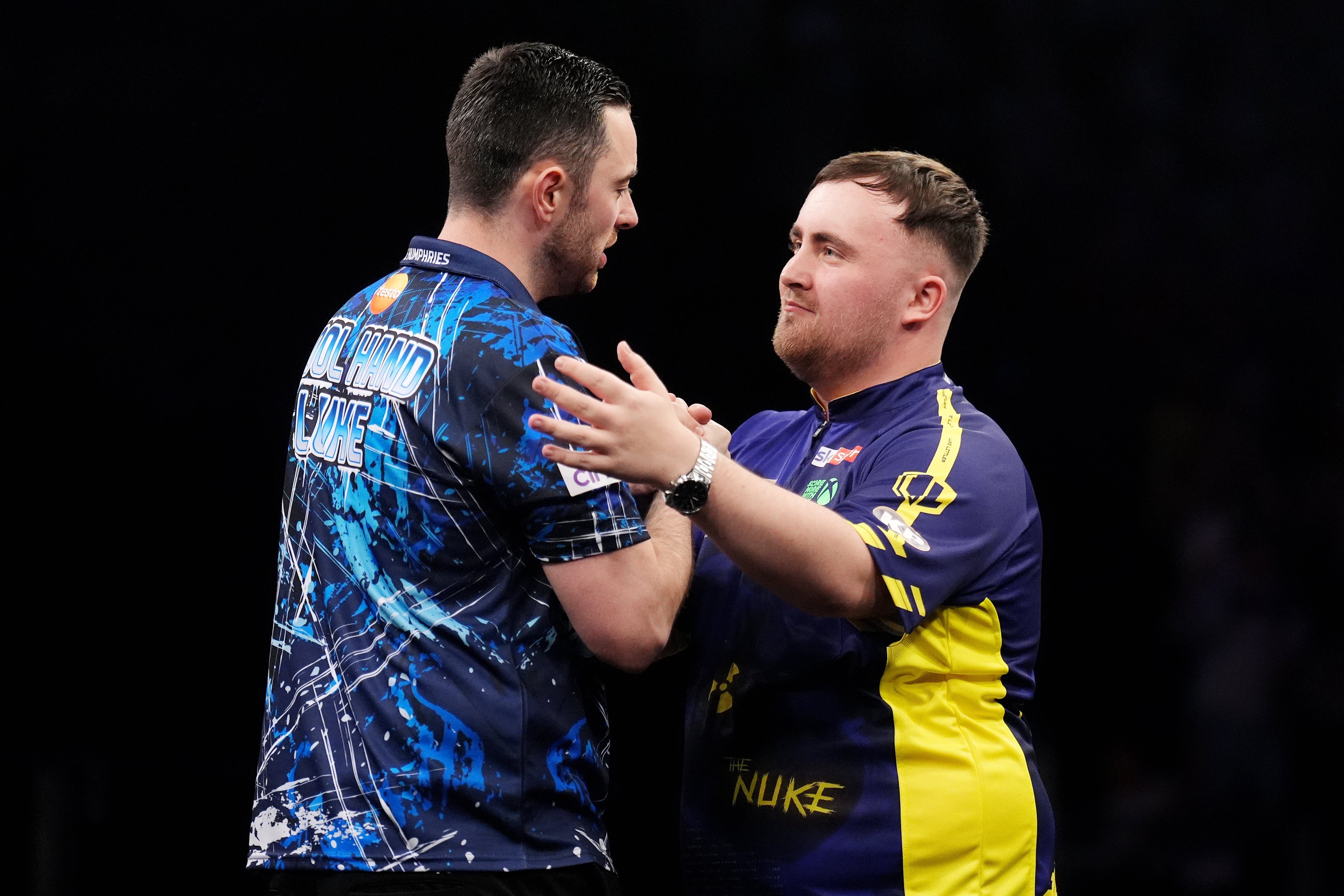 Luke Humphries, left, is embraced by Luke Littler (John Walton/PA)