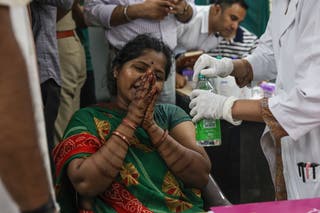A relative of a victim who died in an airplane crash, mourns as she arrives to provide a DNA sample in order to claim the body at Civil Hospital in Ahmedabad, Gujarat