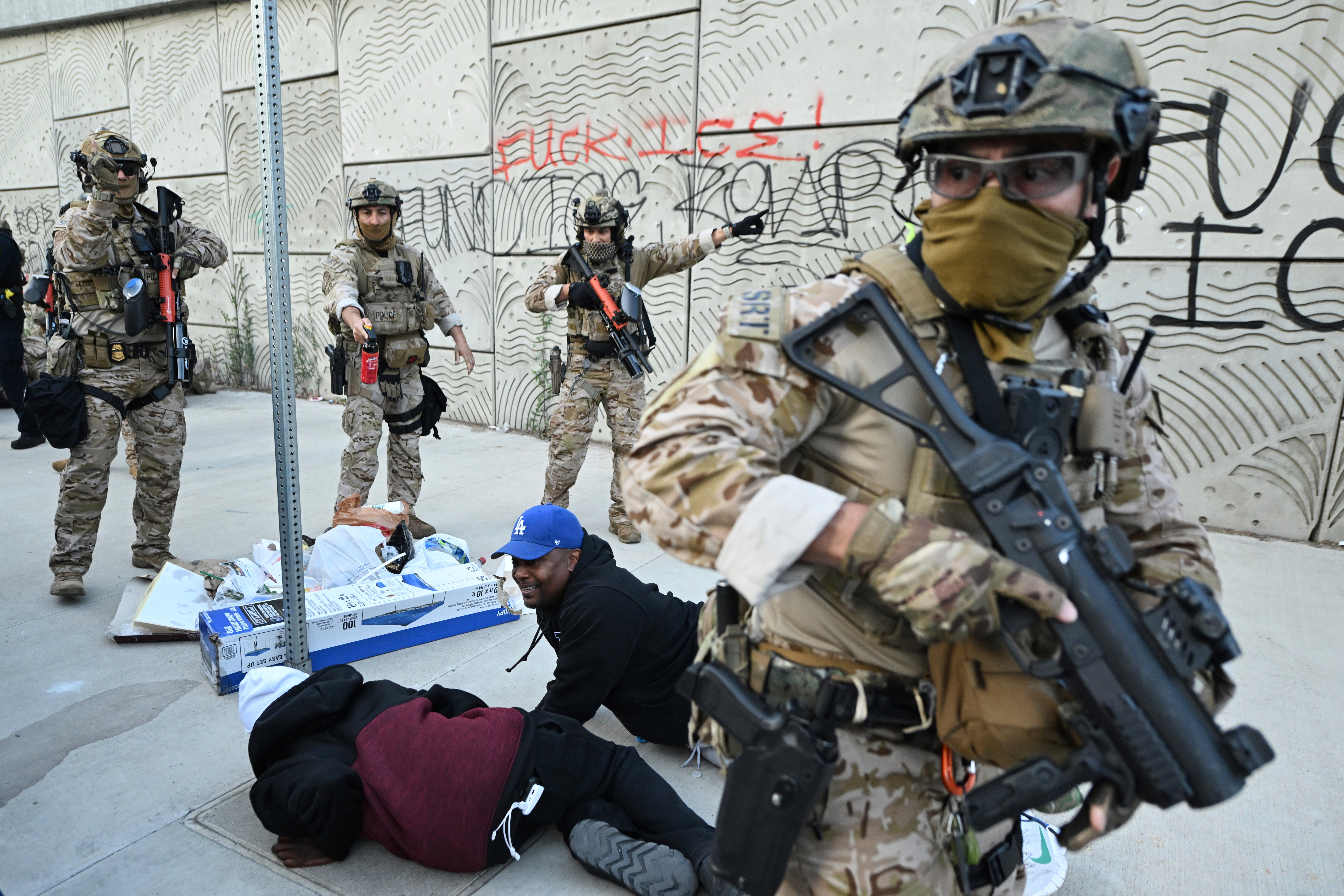 A Special Response Team of the Customs and Border Protection clashes with protestors in LA on Thursday