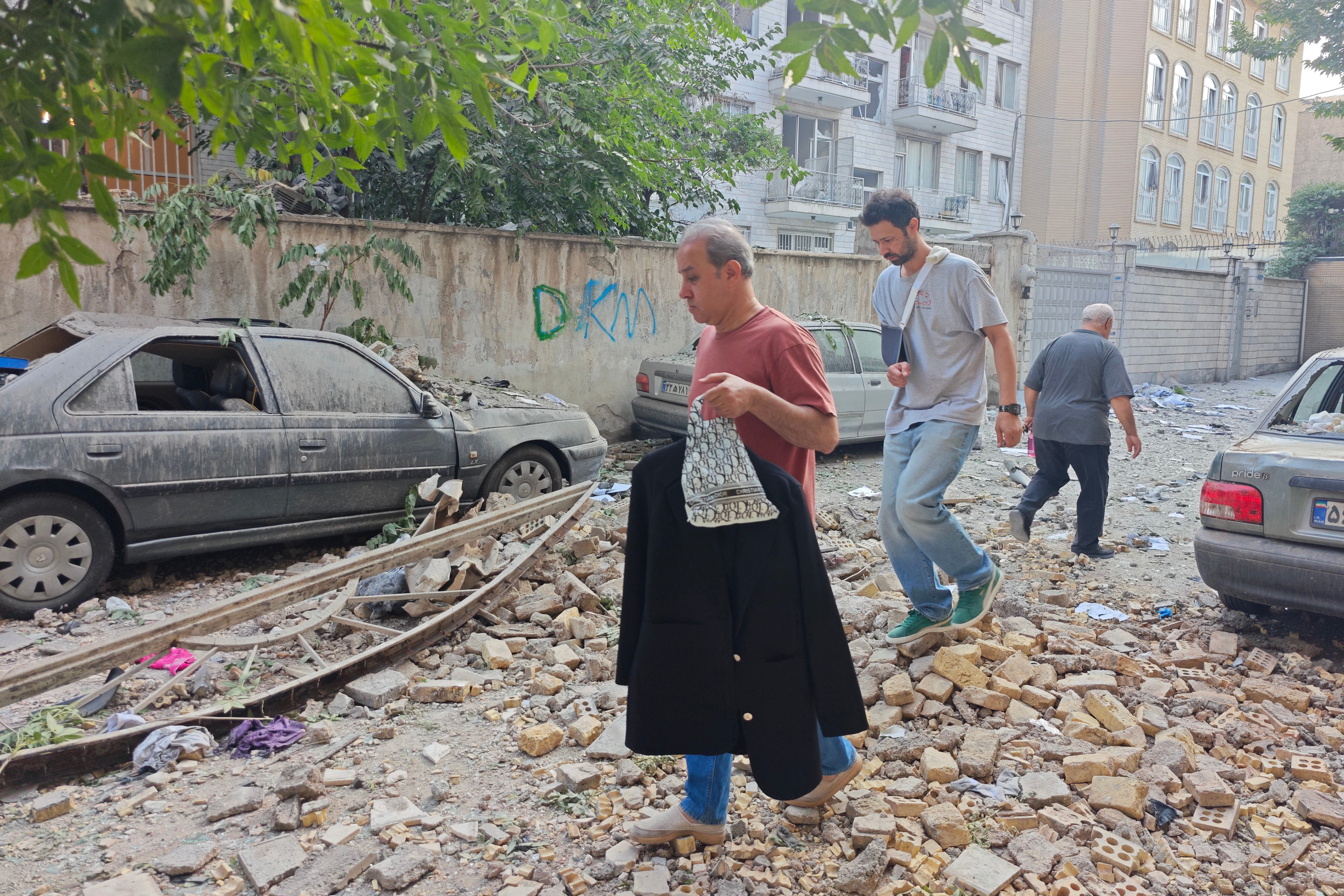 People look over damage following Israeli airstrikes on June 13, 2025 in Tehran, Iran