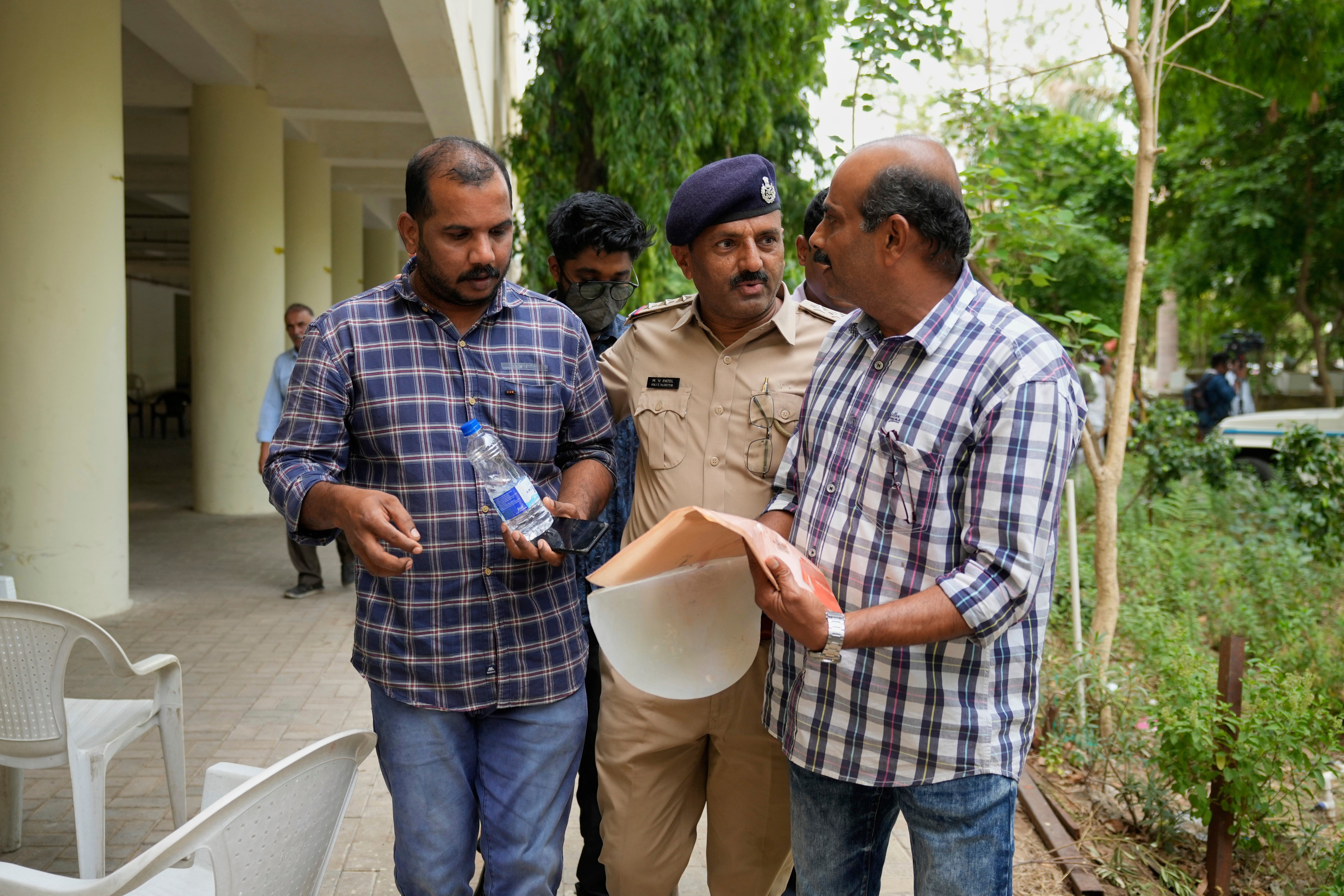 Ratheesh Nair, left, brother of Air India plane crash victim Ranjitha Nair, leaves a hospital after giving his DNA sample to identify his sister's body in Ahmedabad, India, Saturday, 14 June 2025