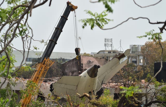 <p>A crane retrieves part of the Air India Boeing 787</p>