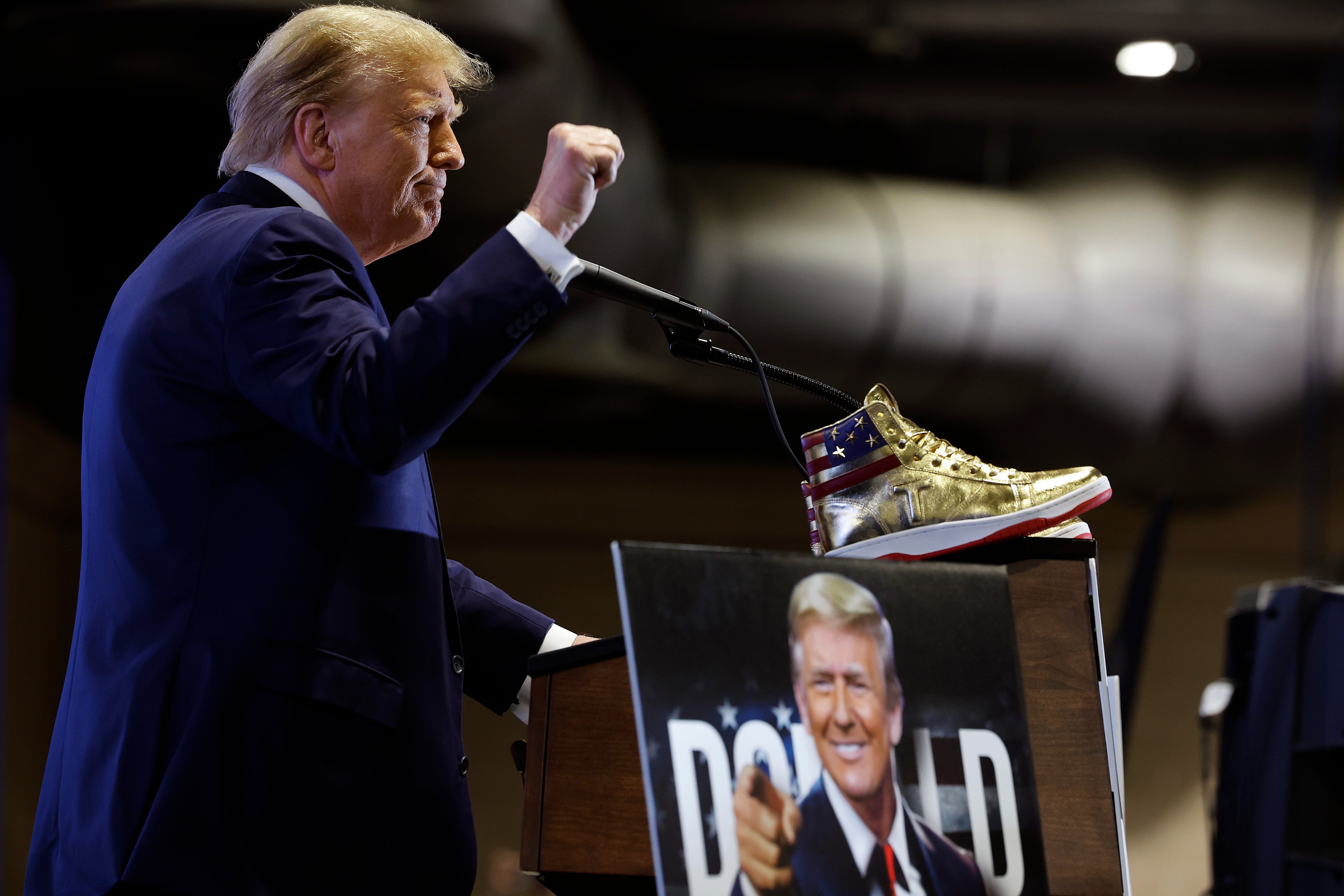 The president, pictured promoting his gold $399 sneakers in 2024, has never shied away from pushing his merchandise on supporters, despite critics accusing him of shameless grift.