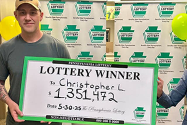<p>Army vet Christopher Lehman collected his $1.3 million prize money with a commemorative check.</p>
