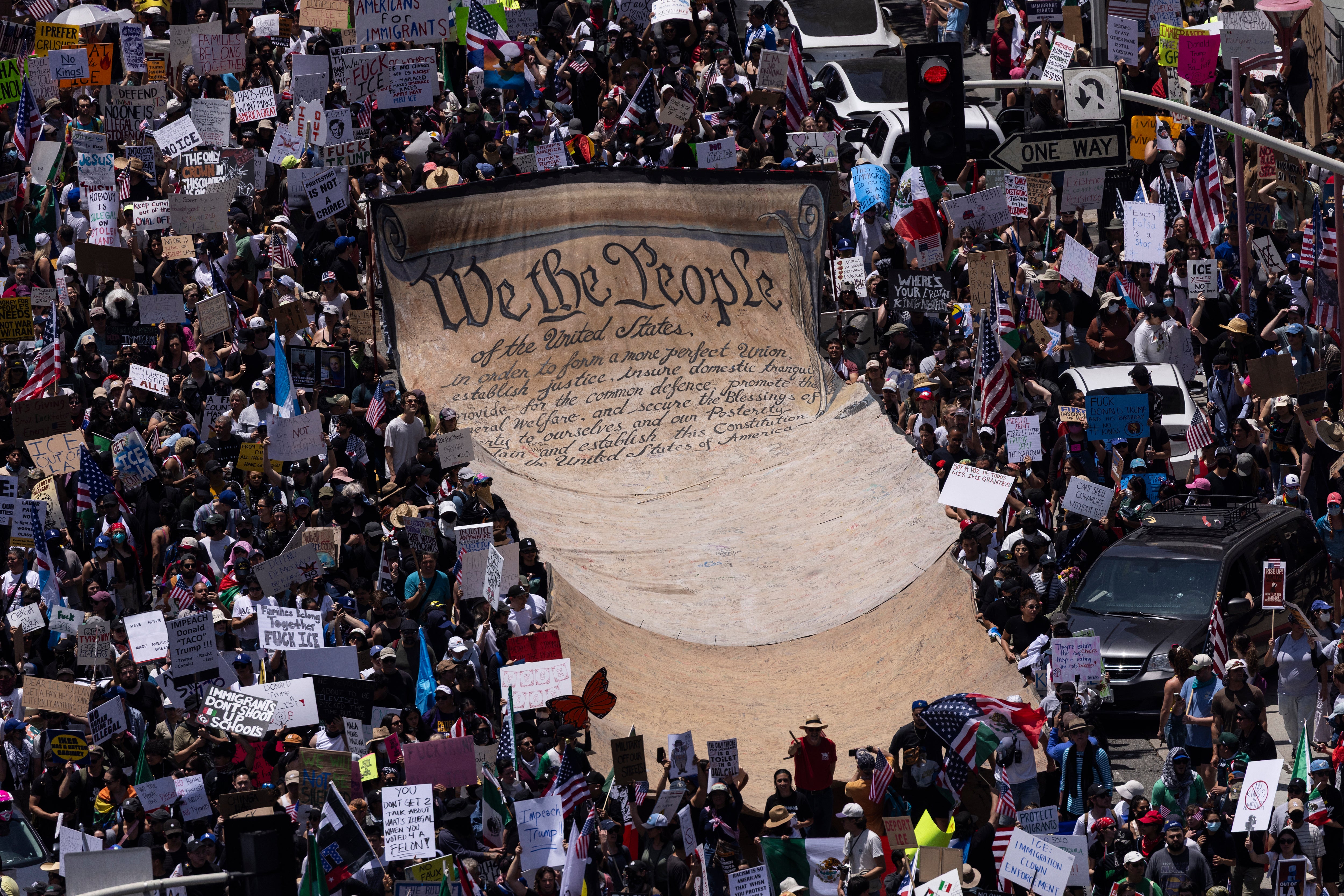 More than 20,000 people marched through Los Angeles where demonstrators deployed a giant banner of the Constitution