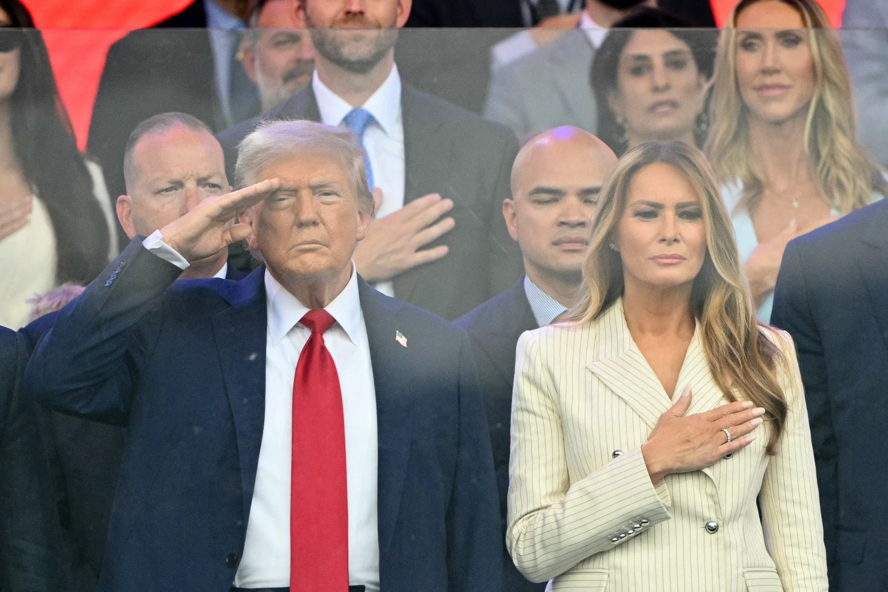 Tanks rolled by Trump and the first lady of Melania Trump while watching the parade from the stands on a dark and cloudy night in Washington, DC