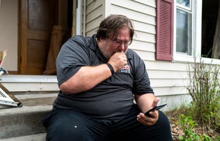 David Carlson reads a text message he claims he received Saturday morning from the suspect, who his friend of 50 is.