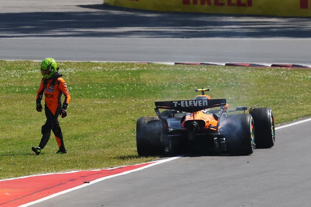 <p>Lando Norris walks away from his stricken McLaren car after his collision with Oscar Piastri</p>