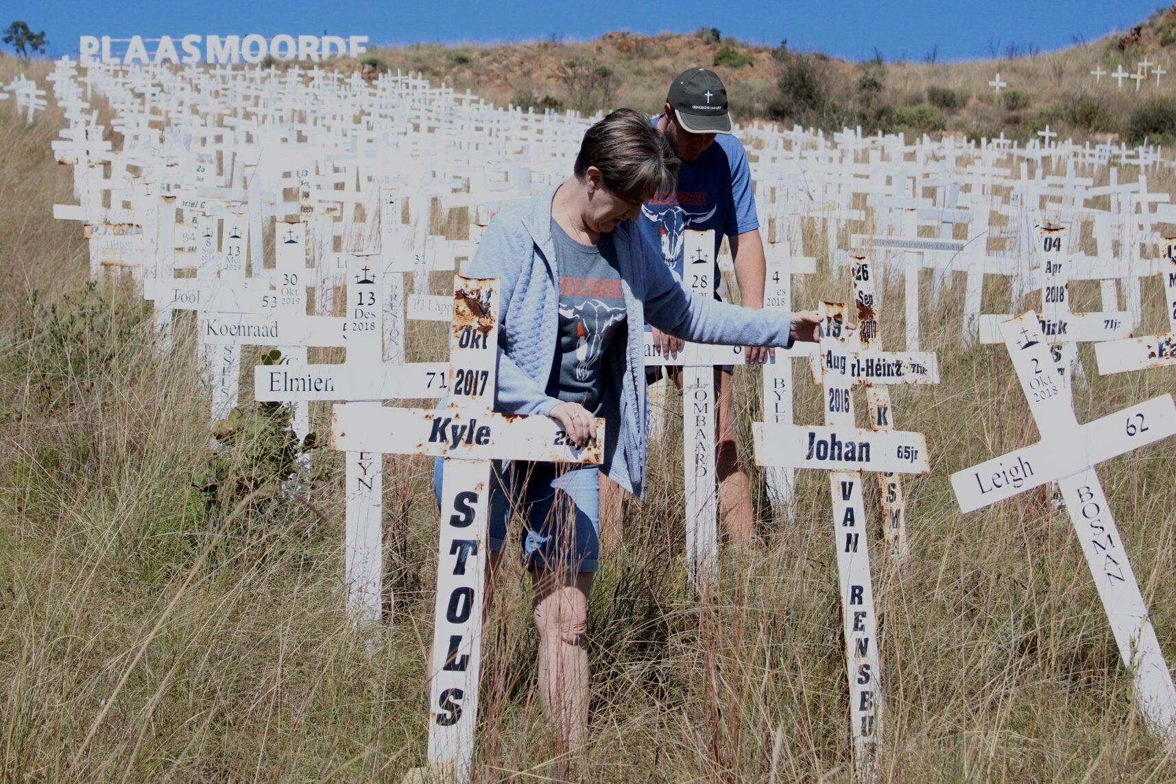 Anita de Lange, left, and her son, Hansie de Lange, tidy up at the Witkruis Monument, near Polokwane, South Africa