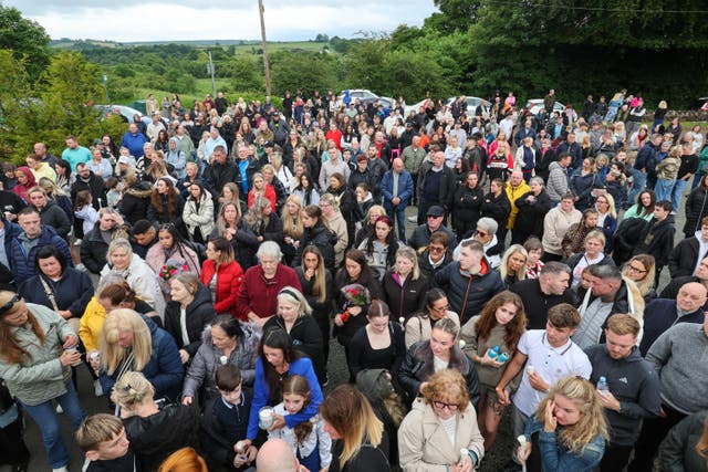 People attend a vigil at the Glenskirlie Hotel in Banknock, for Cole Cooper (Robert Perry/PA Wire)