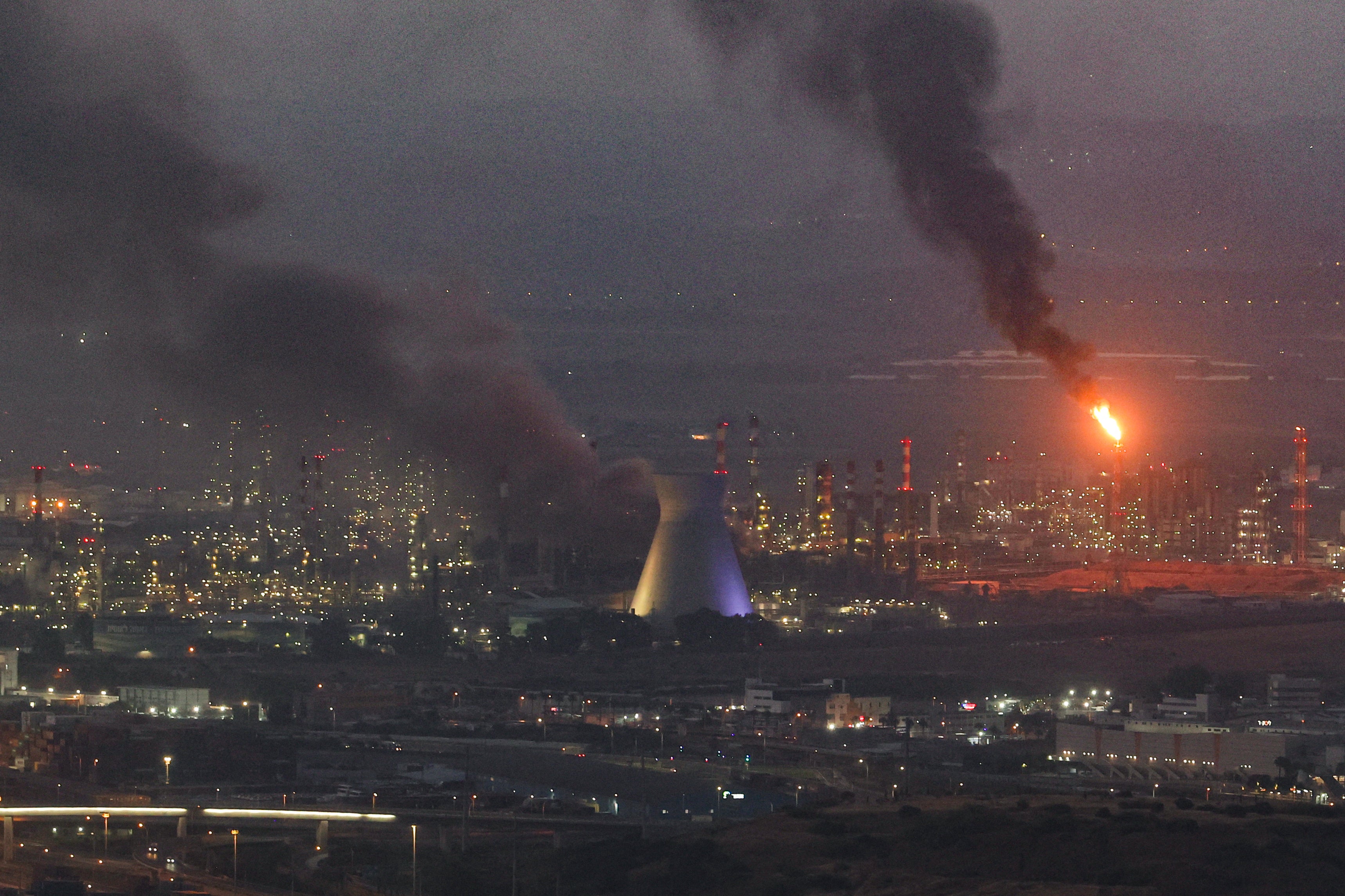 Smoke billows from a site in the city of Haifa on 16 June 2025