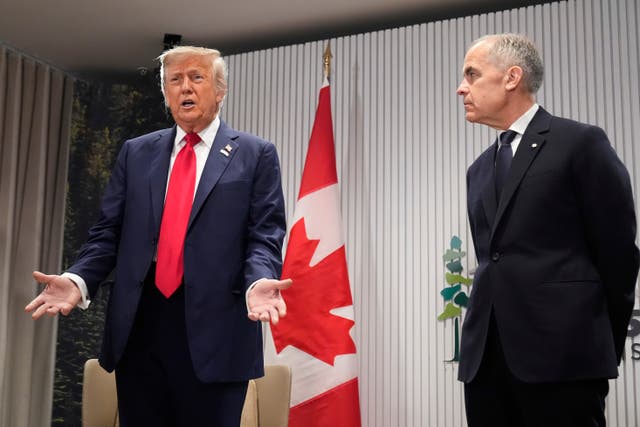 <p>Awkward moment: Donald Trump standing next to Canada's Mark Carney at the G7 in Kananaskis, Canada</p>