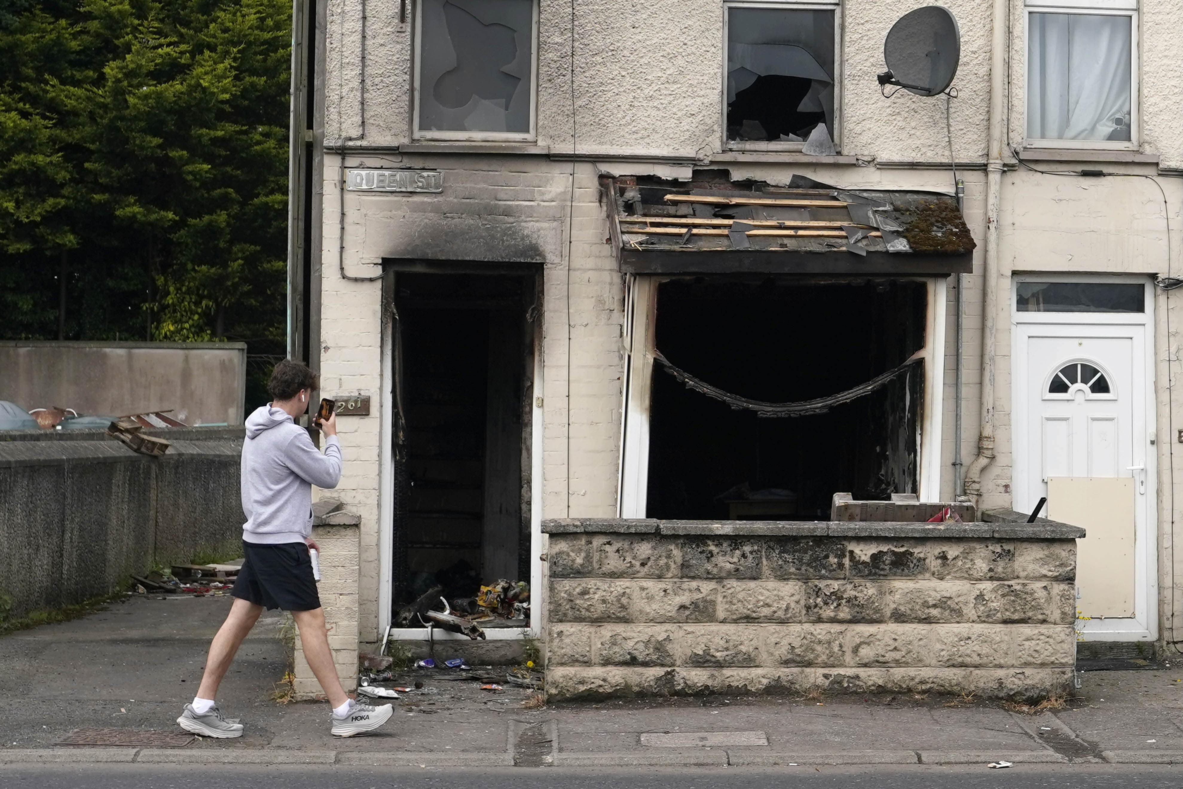 A burnt out house on Queen Street following a second night of violence in Ballymena (PA)