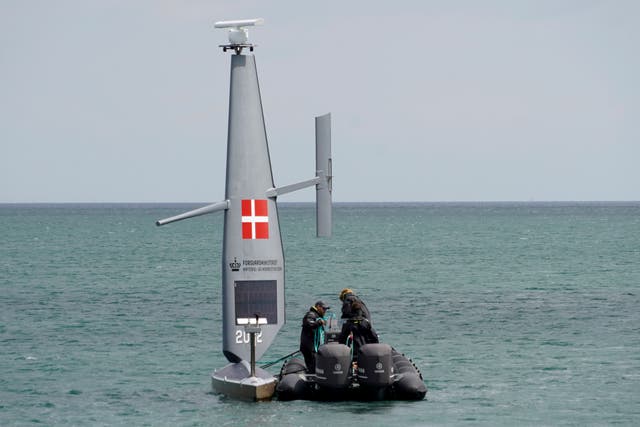 <p>Workers deploy a Saildrone "Voyager", uncrewed surface vehicle (USV), into the Baltic Sea at the Koge Marina in Koge, eastern Denmark</p>