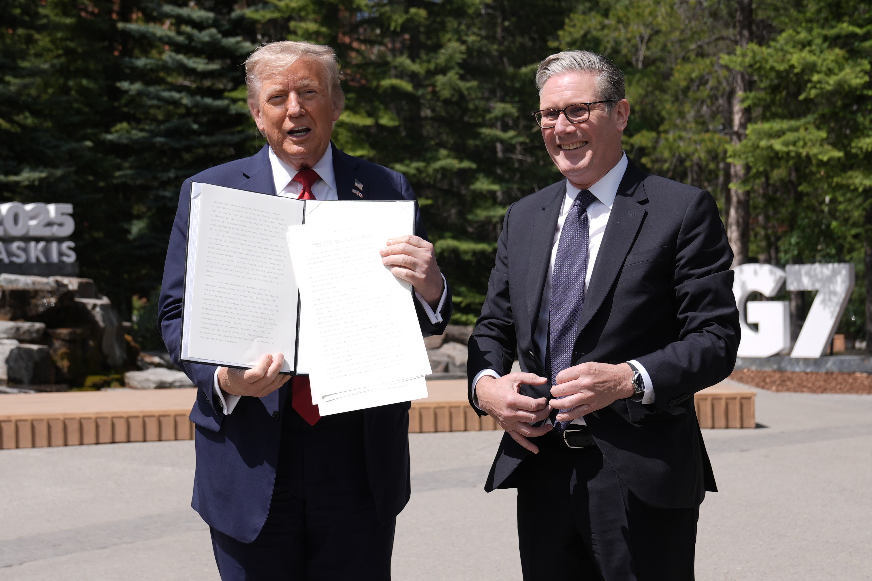 US President Donald Trump (left) holding a UK US trade deal with Prime Minister Sir Keir Starmer while speaking to the media at the G7 summit in Kananaskis, Alberta, Canada. (Stefan Rousseau/PA)