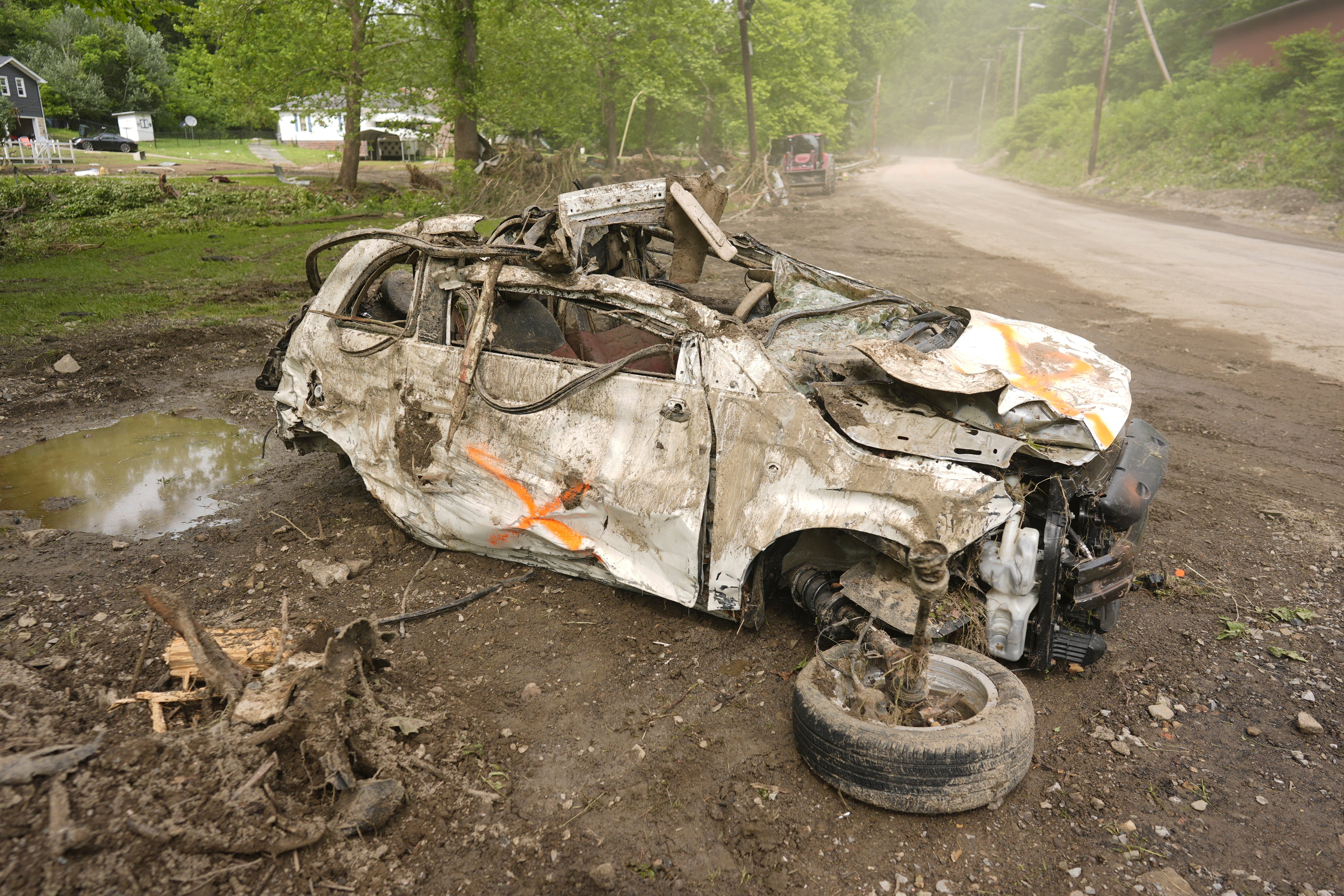 A washed out vehicle sits in flood debris from Battle Run Creek, West Virginia
