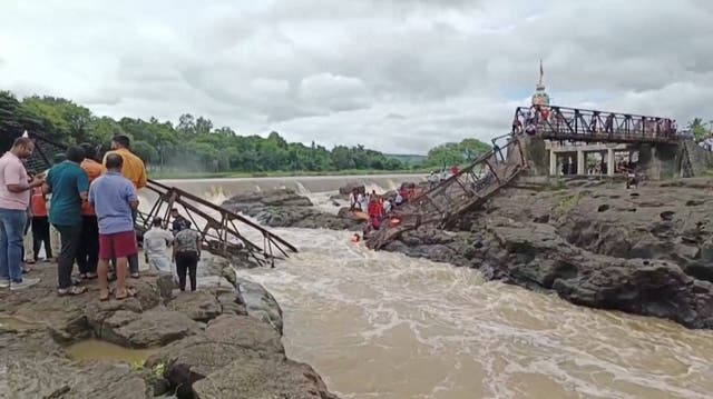 <p>People gather following a bridge collapse over the Indrayani river in the western Indian city, in Pune</p>