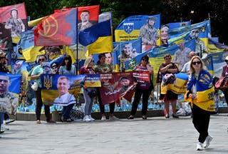 Relatives and friends of Ukrainian prisoners of war hold portraits of them during a rally