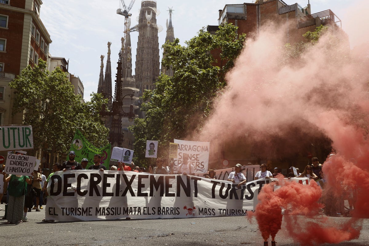 Holidaymakers sprayed by water pistols in Barcelona as part of organised anti-tourism protests across Europe